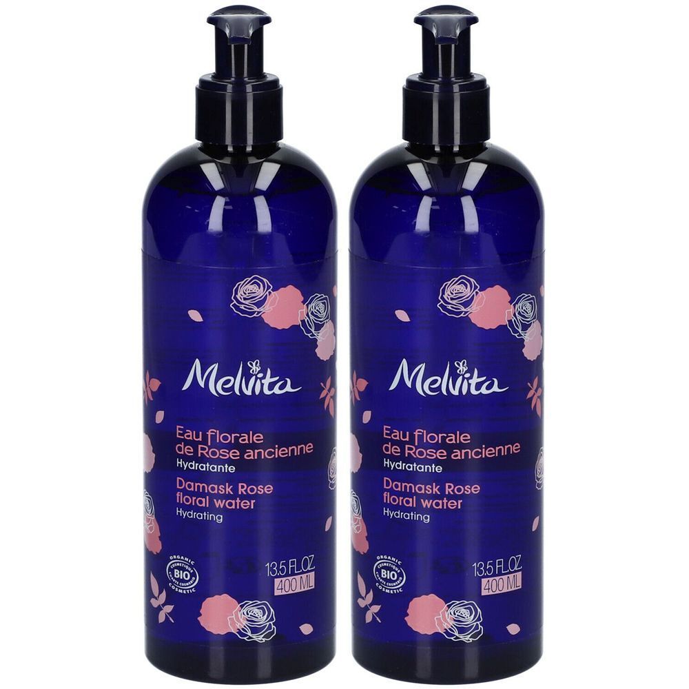 Deux flacons d'eau florale de rose Melvita avec pompes. Flacons bleus décorés de roses et du label Bio.