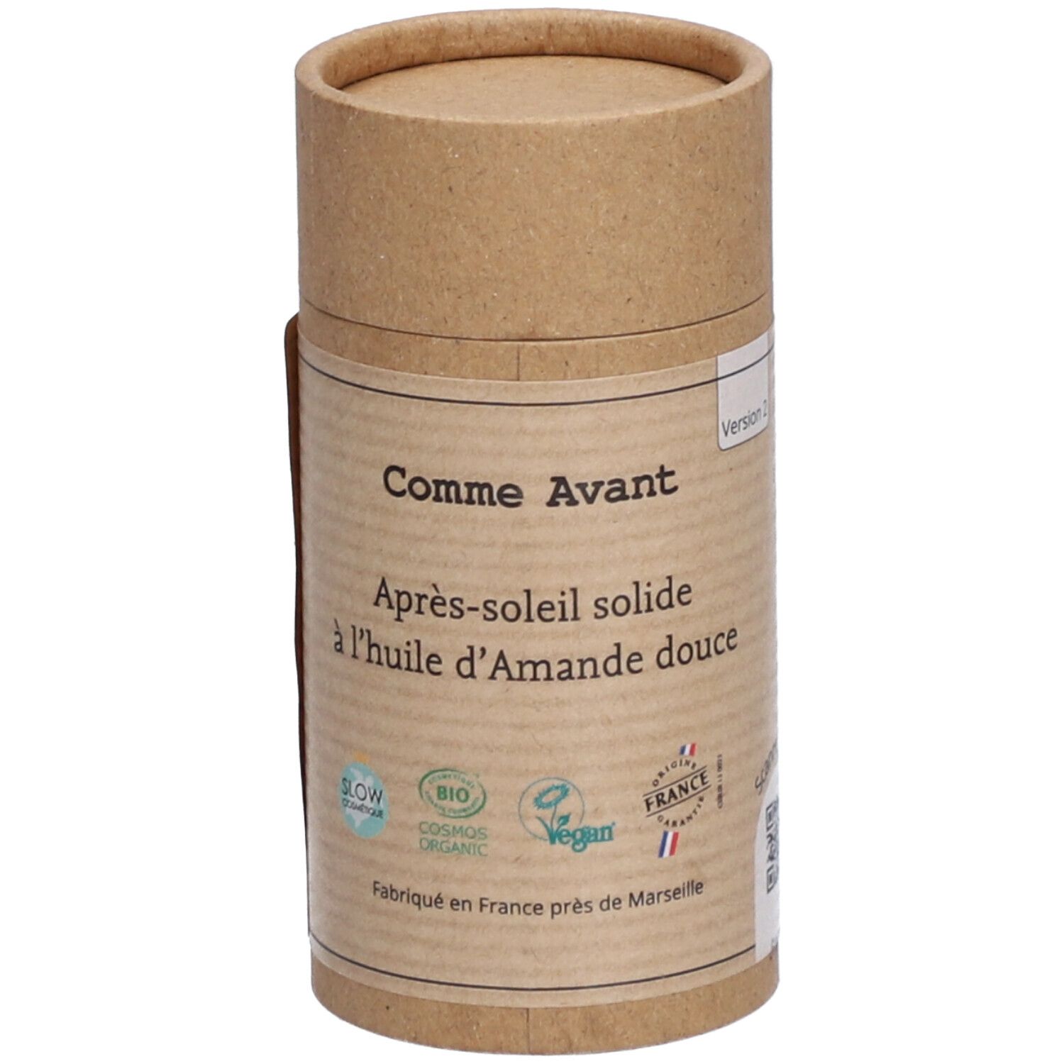 Emballage cylindrique. Inscription: Comme Avant, Après-soleil solide à l'huile d'Amande douce. Logos: Slow cosmétique, Bio, Vegan.