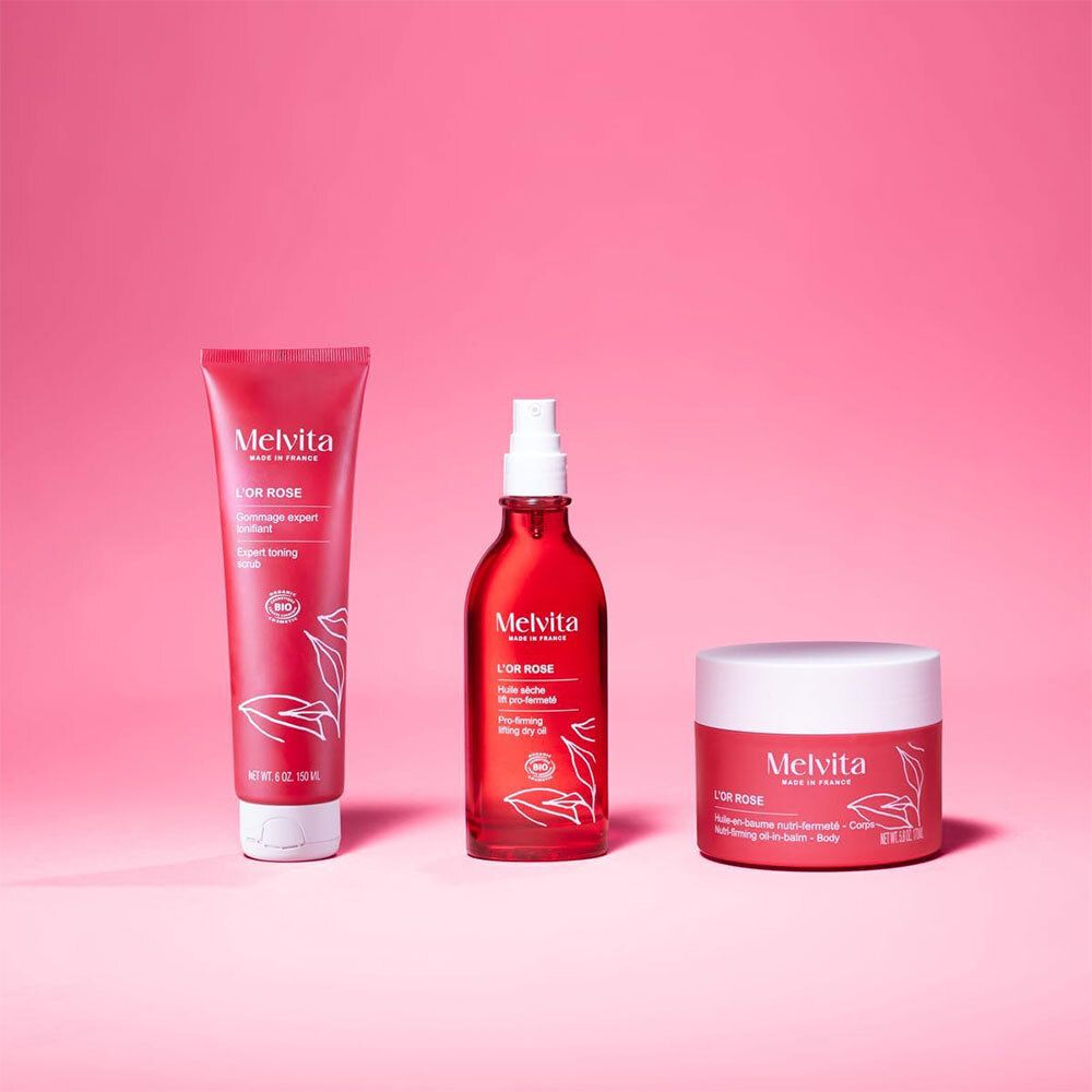 Produits de soin corps Melvita L'Or Rose : tube, flacon spray et pot.