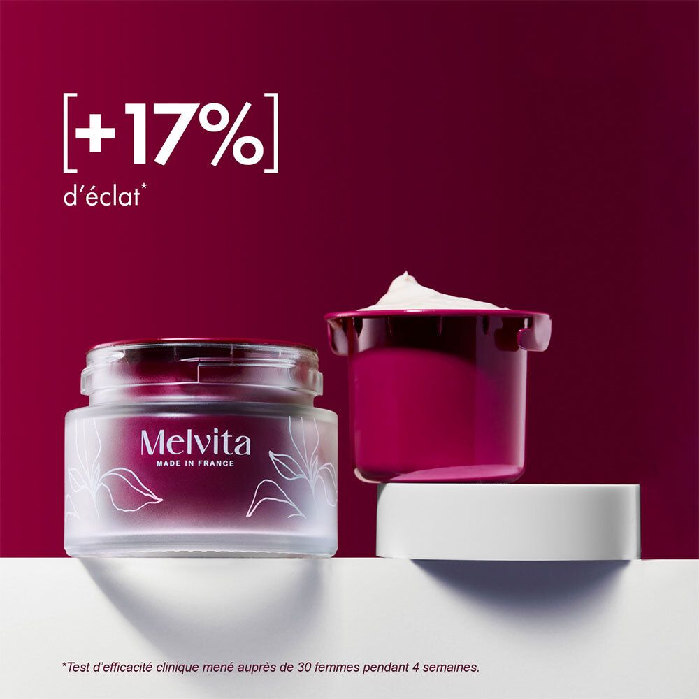 Pot en verre avec couvercle et crème rose. Melvita, Made in France. Un couvercle ouvert. Texte : +17% d'éclat.