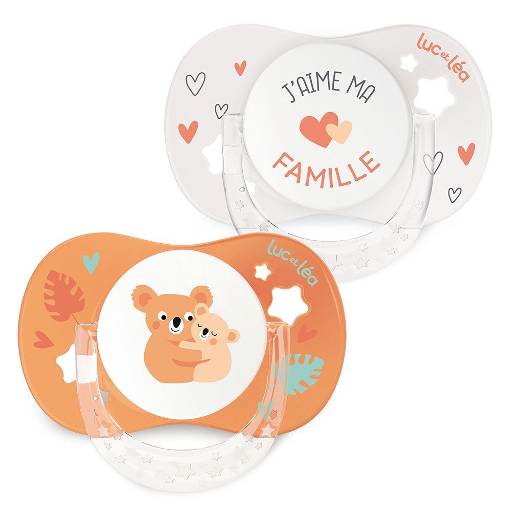 Deux sucettes anatomiques. Une blanche imprimée, une orange avec un motif koala. Marque : Luc et Léa.