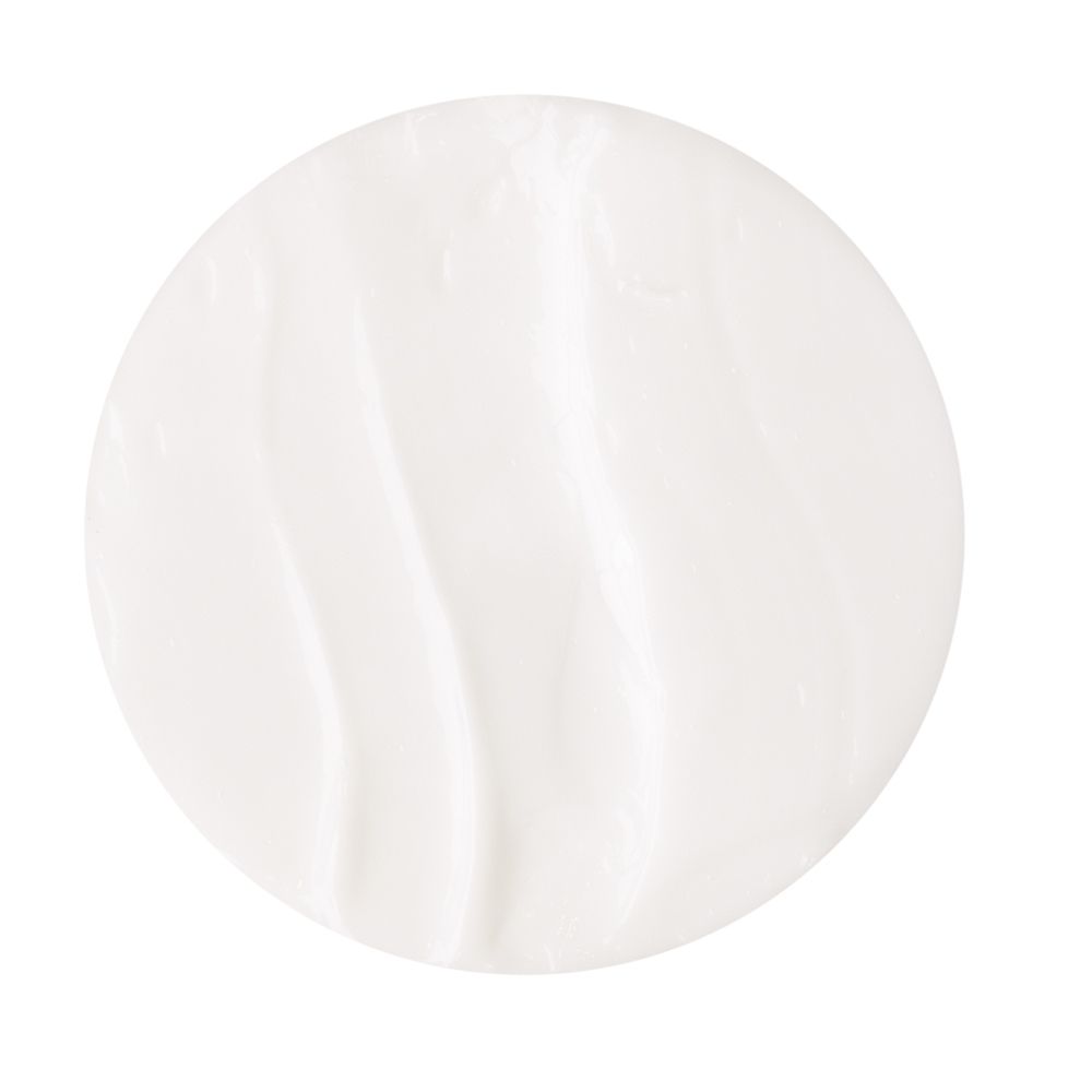 Gros plan de DEXERYL Crème. Crème blanche sur fond blanc. Texture lisse.