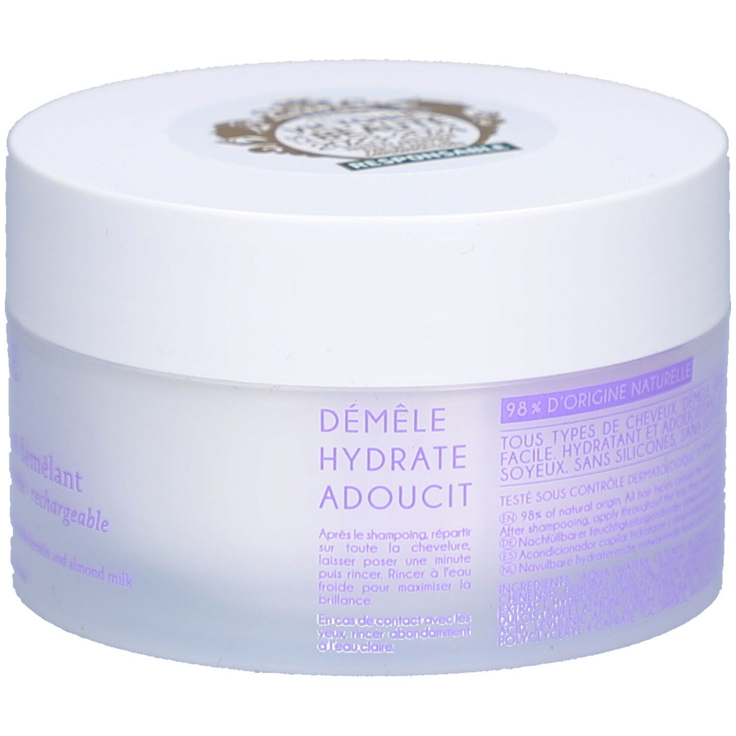 Pot blanc avec couvercle. Inscription : Démêle, hydrate, adoucit. 98% d'origine naturelle. Pour tous types de cheveux.