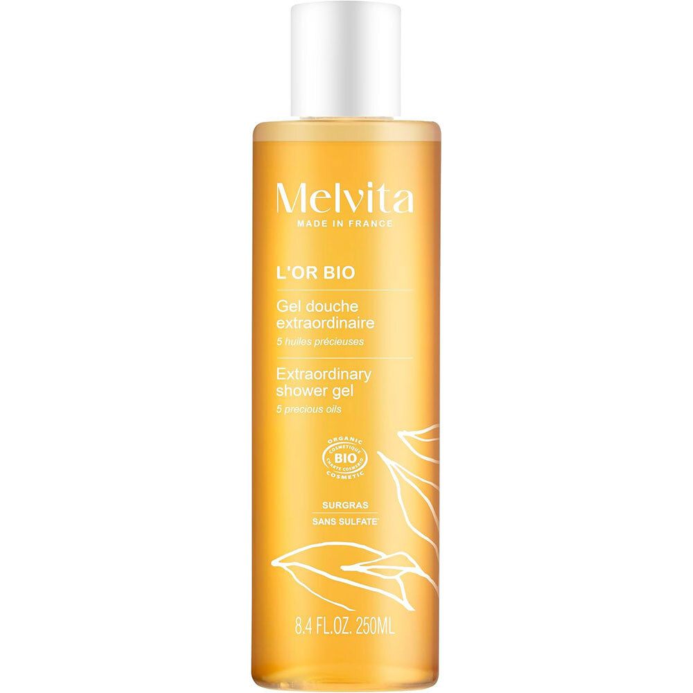 Gel douche extraordinaire Melvita, flacon transparent, liquide doré, bouchon blanc. Logo, certification bio, 250ml.