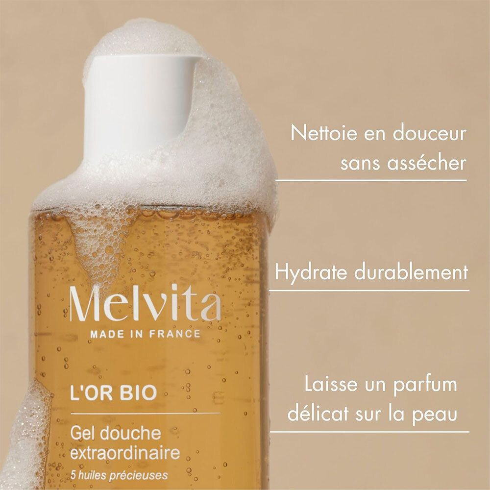 Melvita L'Or Bio Gel Douche Extraordinaire. Flacon avec mousse. Textes: Nettoie, hydrate, parfum.