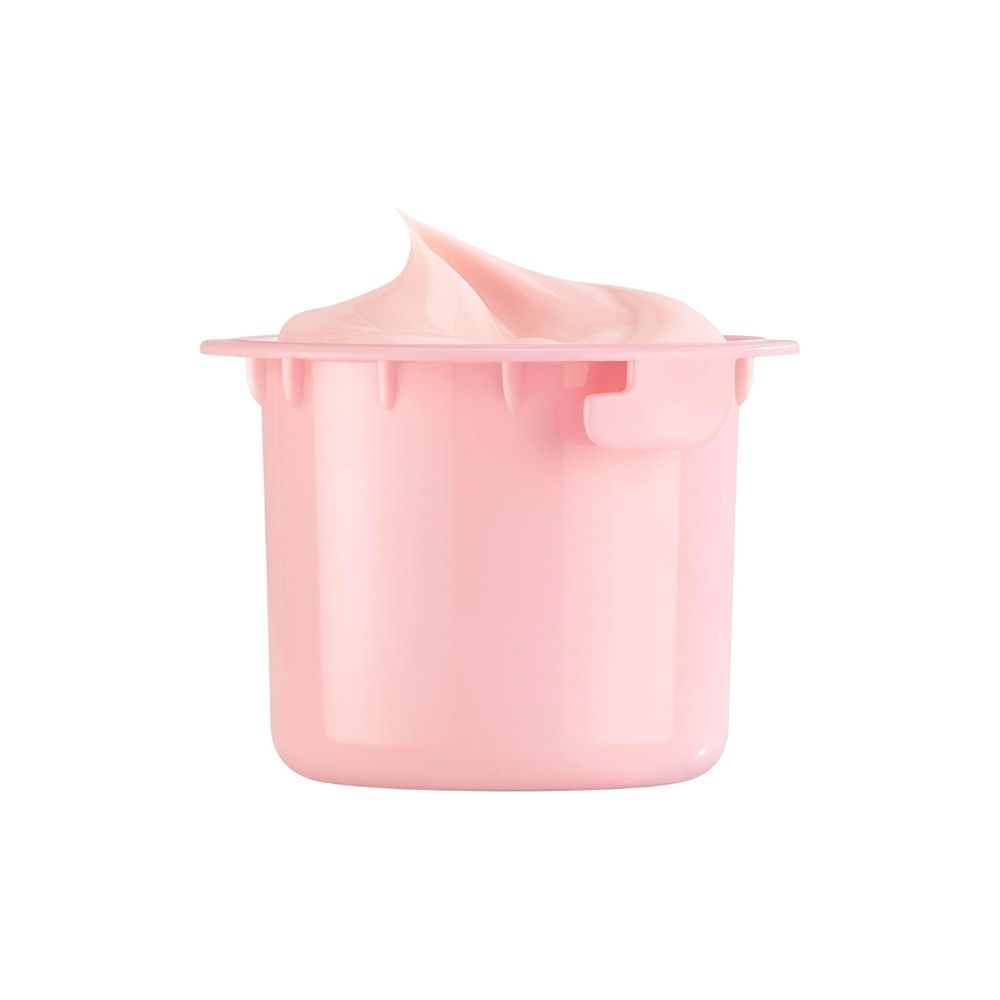 Un petit pot rose contenant une substance crémeuse rose débordant sur le dessus.