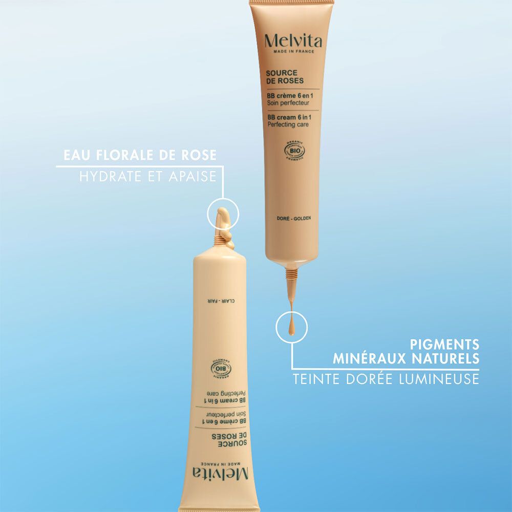 Deux tubes de BB Cream. Gouttes. Pigments minéraux naturels. Teinte dorée lumineuse. Fond bleu.