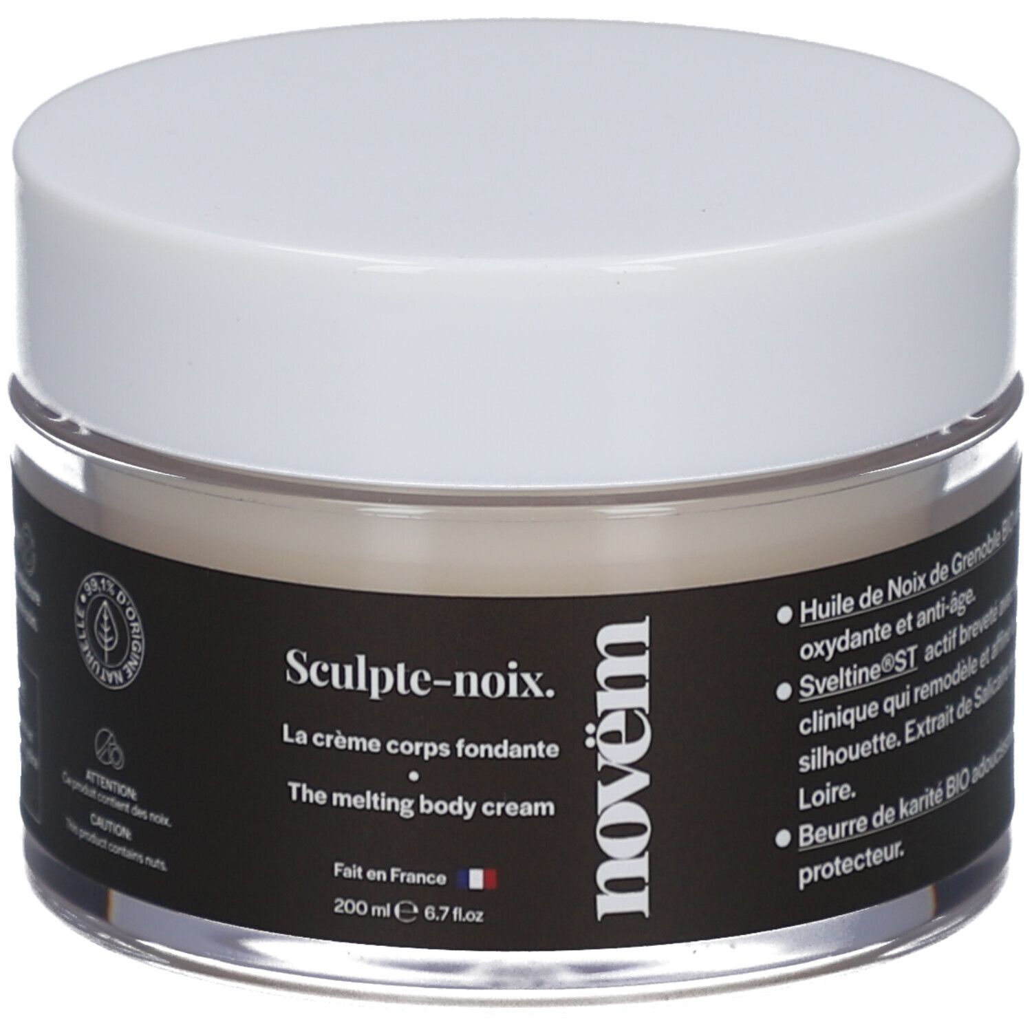 Pot de crème avec couvercle blanc. Étiquette noire avec texte: Sculpt-noix, La crème corps fondante, novëm. 200 ml. Verre transparent.