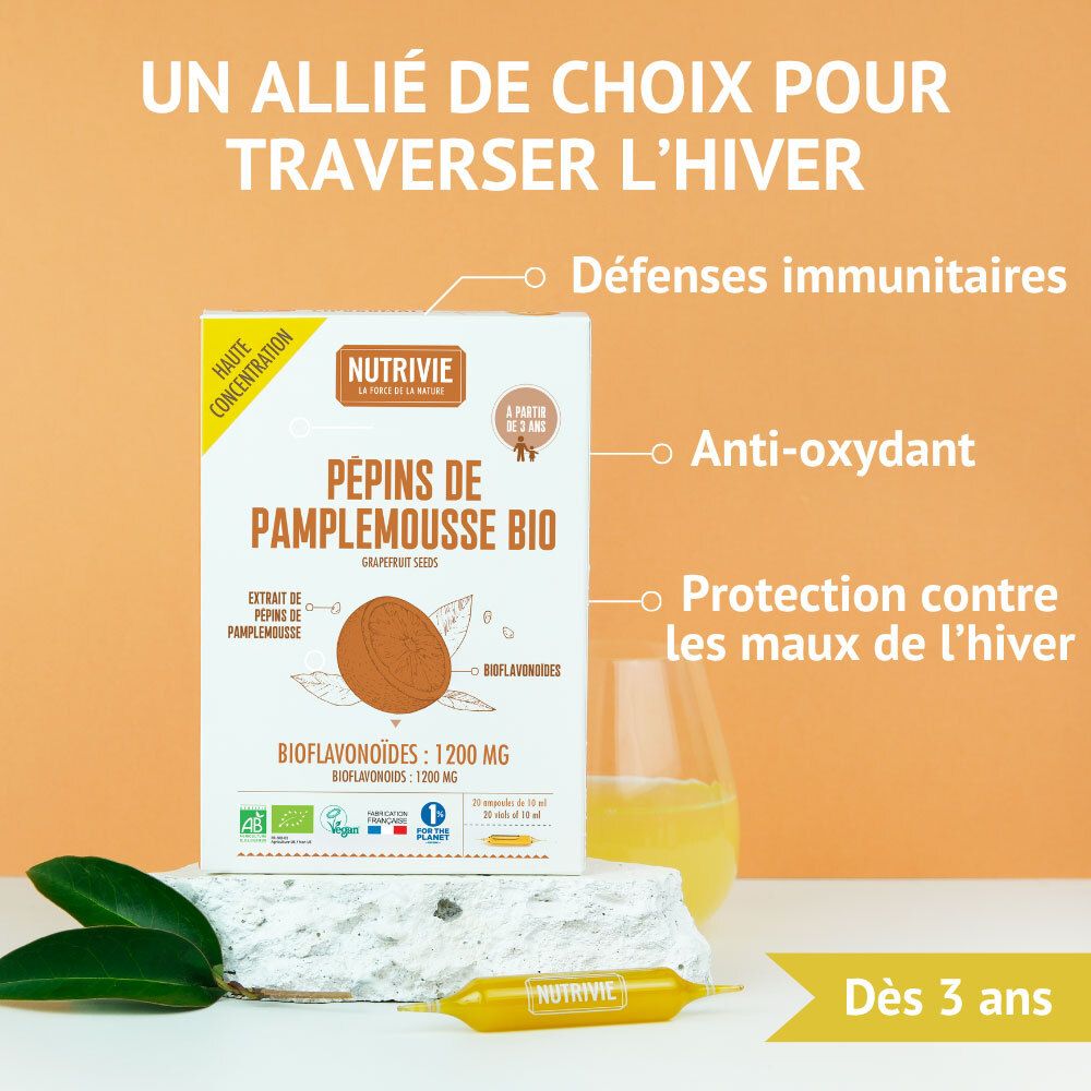 Nutrivie Pépins de Pamplemousse Bio, boîte à côté d'un verre et de feuilles. Pour l'immunité et l'hiver.