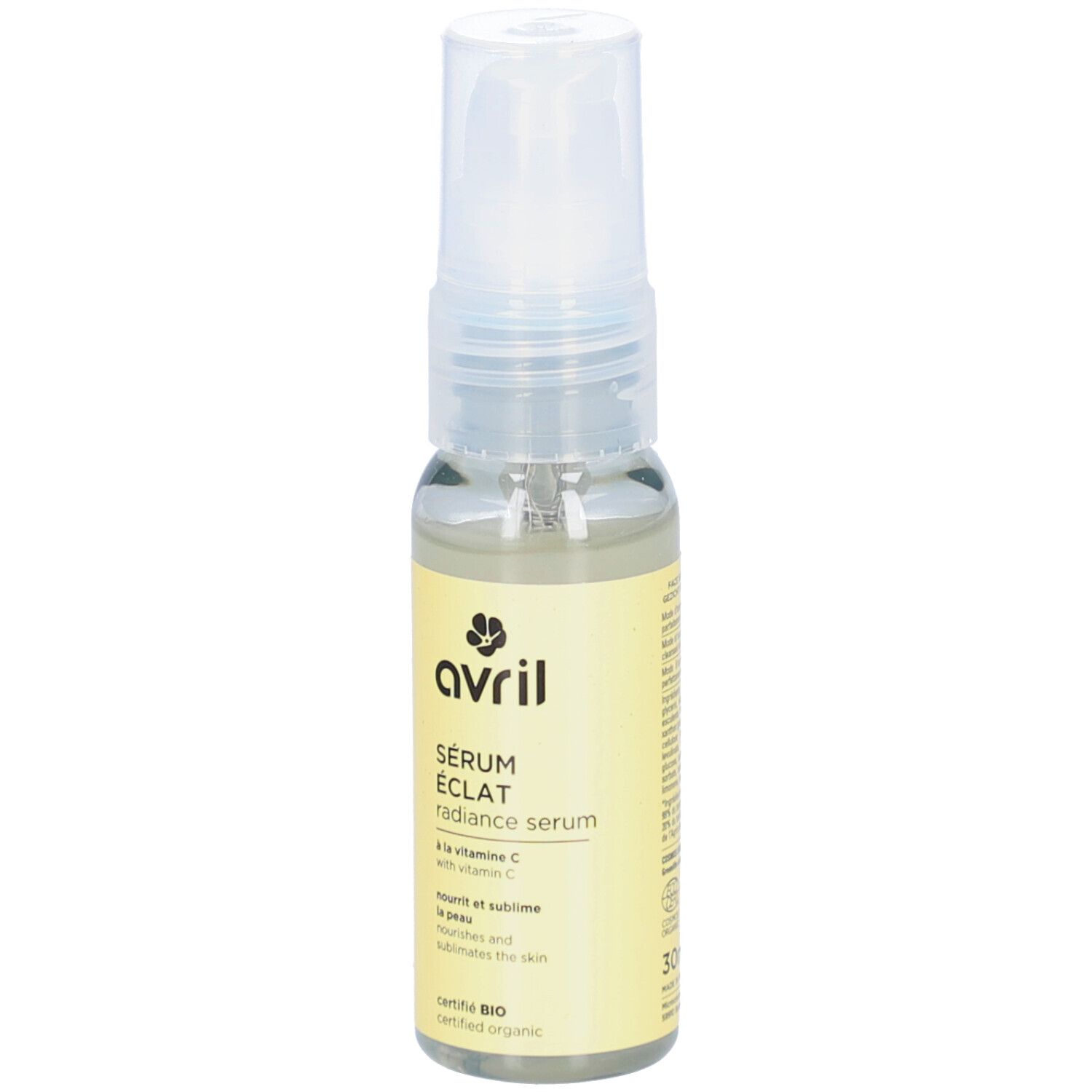 Sérum Eclat AVRIL, liquide transparent en flacon de verre avec vaporisateur. Étiquette jaune avec texte et logo.