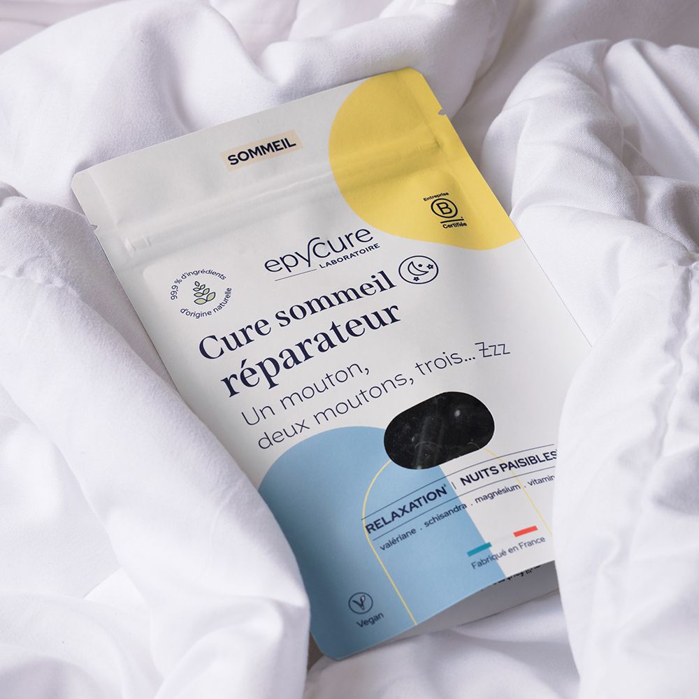 Emballage sur linge de lit blanc. Inscription: Cure sommeil réparateur. Marque: epycure. Gélules visibles. Emballage jaune et blanc.