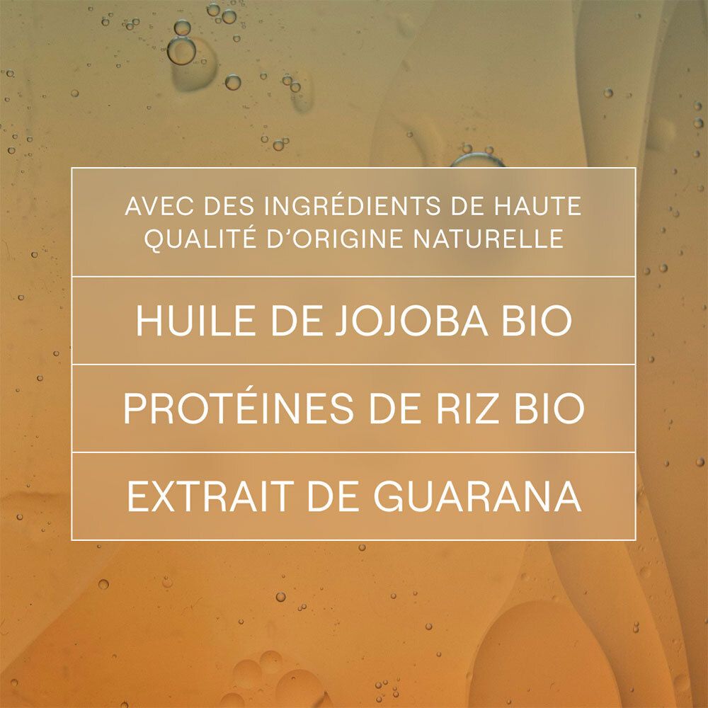 Texte : Ingrédients : huile de jojoba, protéines de riz, extrait de guarana. Sur fond jaune.