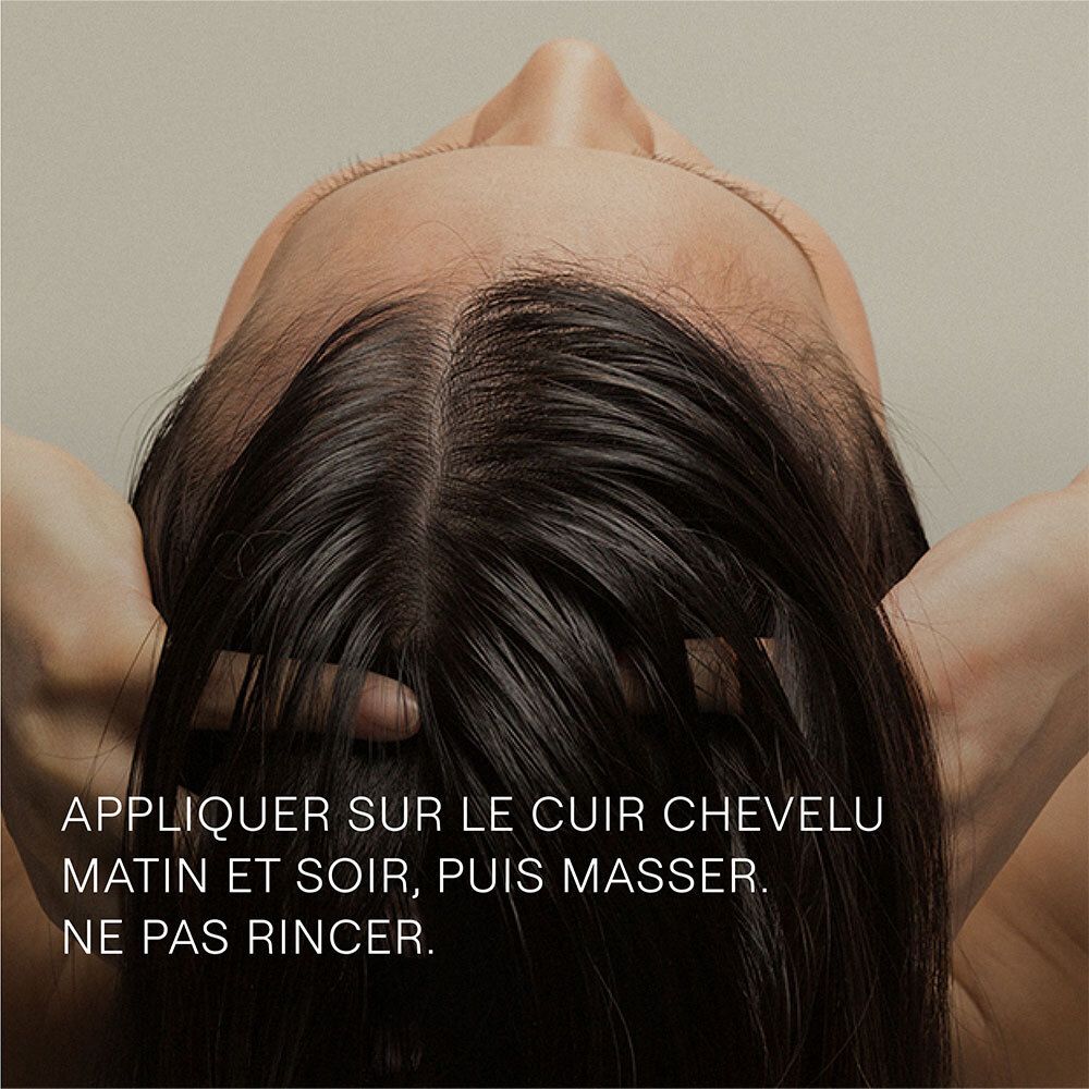 Personne, tête en bas. Texte: Appliquer sur le cuir chevelu matin et soir, puis masser.