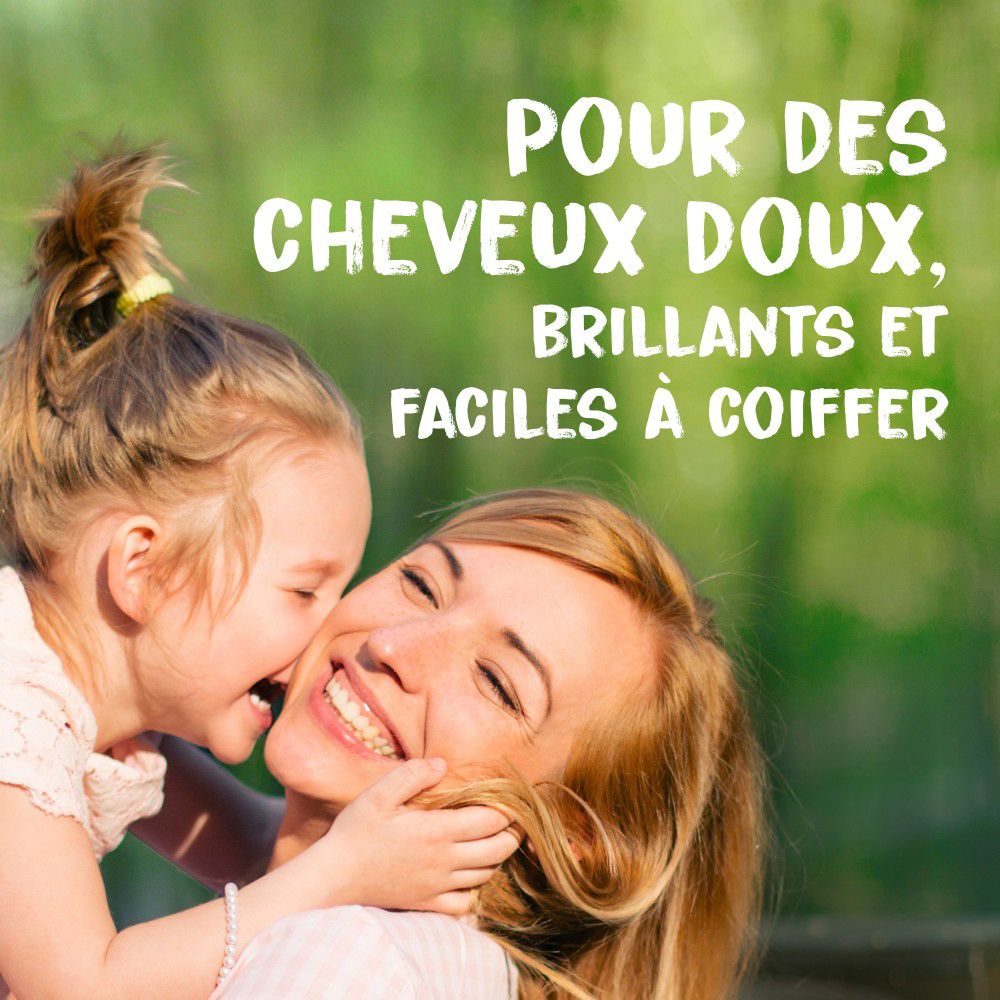 Mère et enfant s'embrassent. Texte: Pour des cheveux doux, brillants et faciles à coiffer.