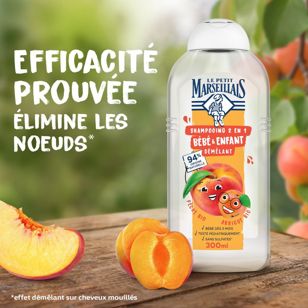 Bouteille de shampooing avec pêche et abricot. Texte: 'Efficacité prouvée, élimine les noeuds'.