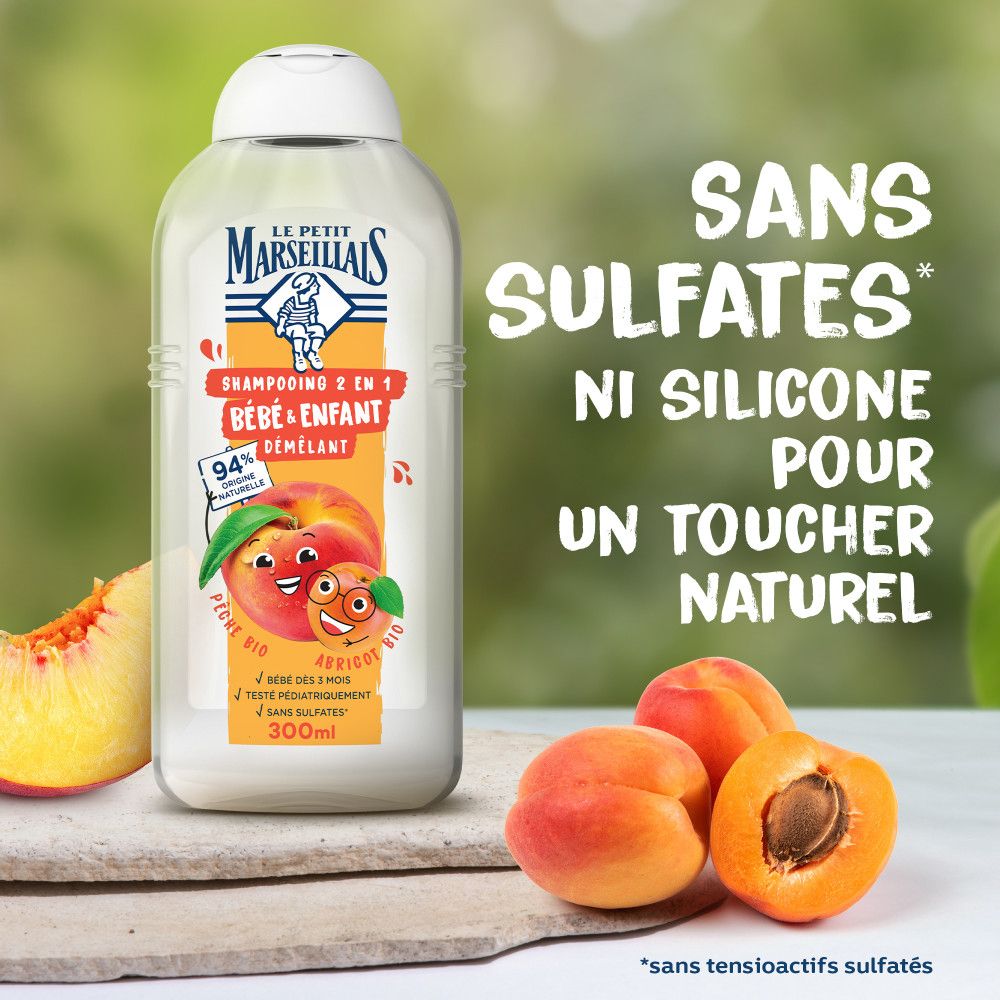 Bouteille de shampooing avec pêche et abricot. Texte: 'Sans sulfates ni silicone'.