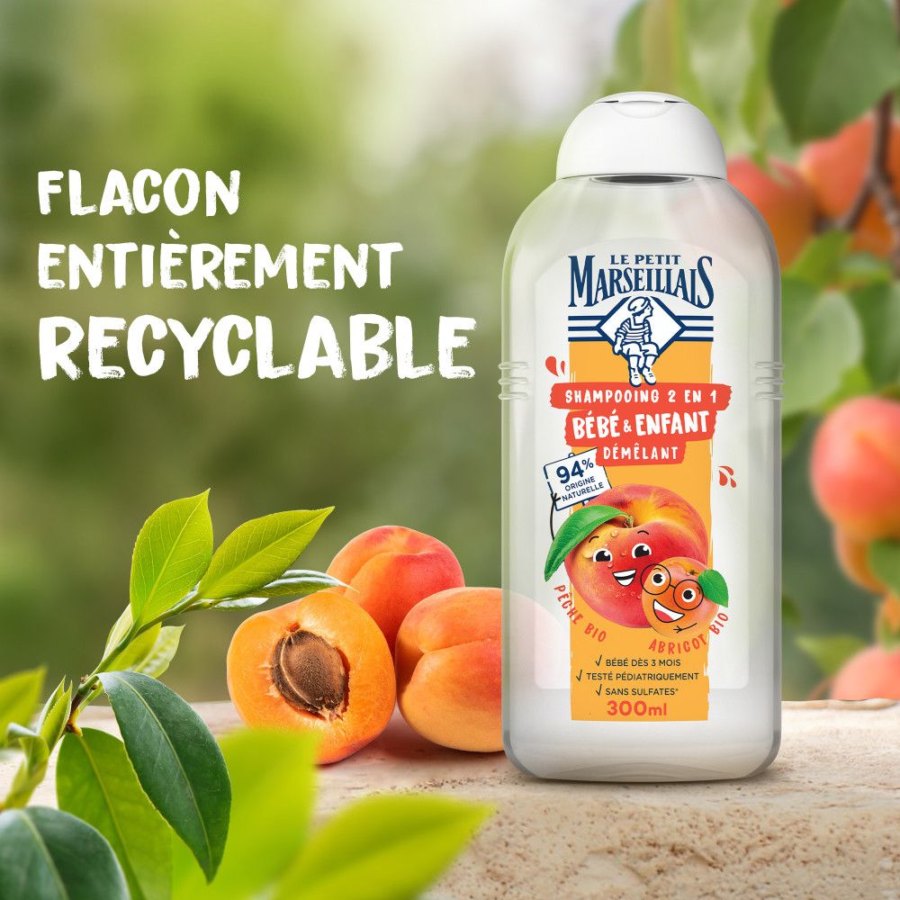 Bouteille de shampooing avec pêche et abricot. Texte: 'Flacon entièrement recyclable'.