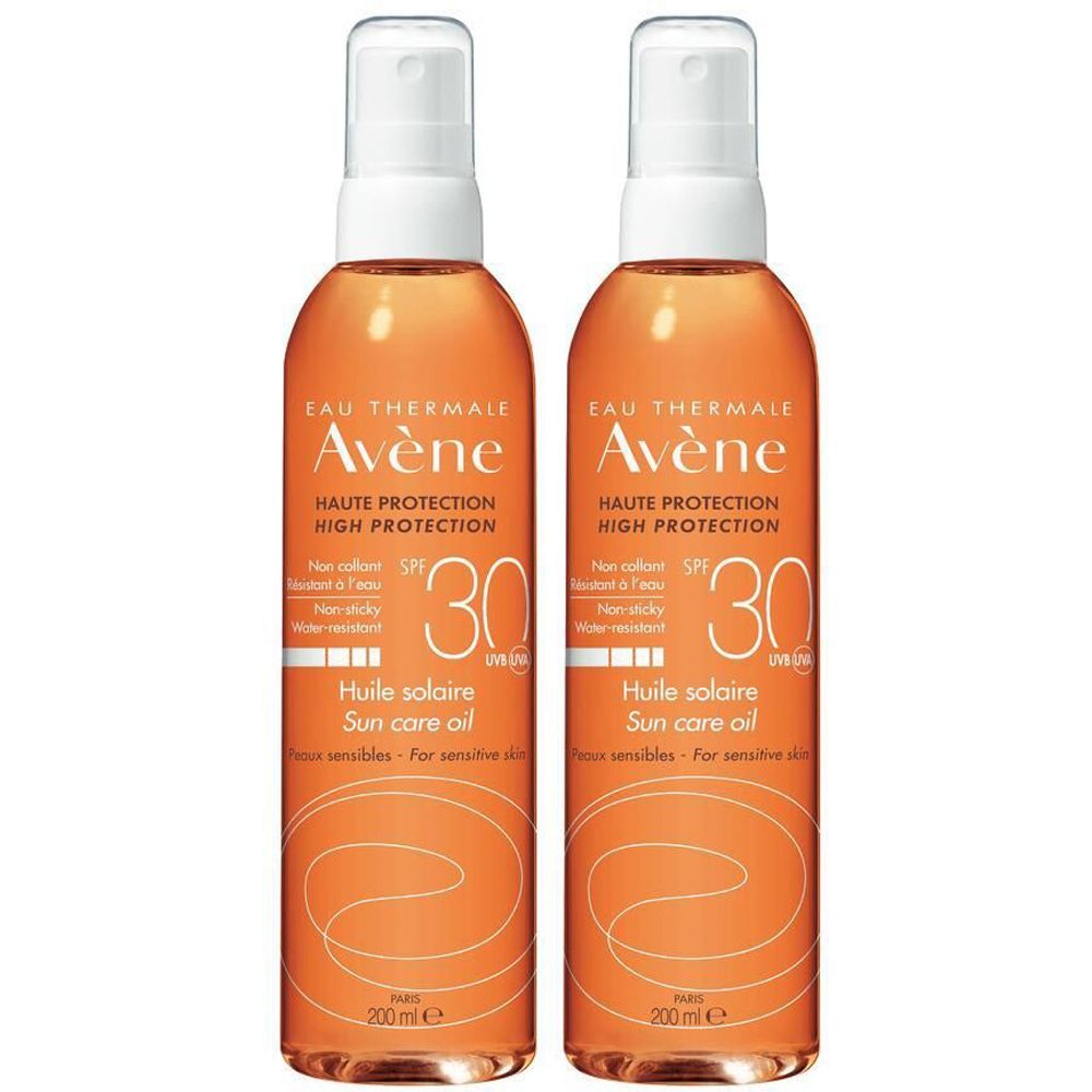 Deux flacons d'huile solaire Avène SPF 30. Liquide orangé dans des flacons transparents avec vaporisateur blanc. Texte: Haute Protection, Huile solaire.