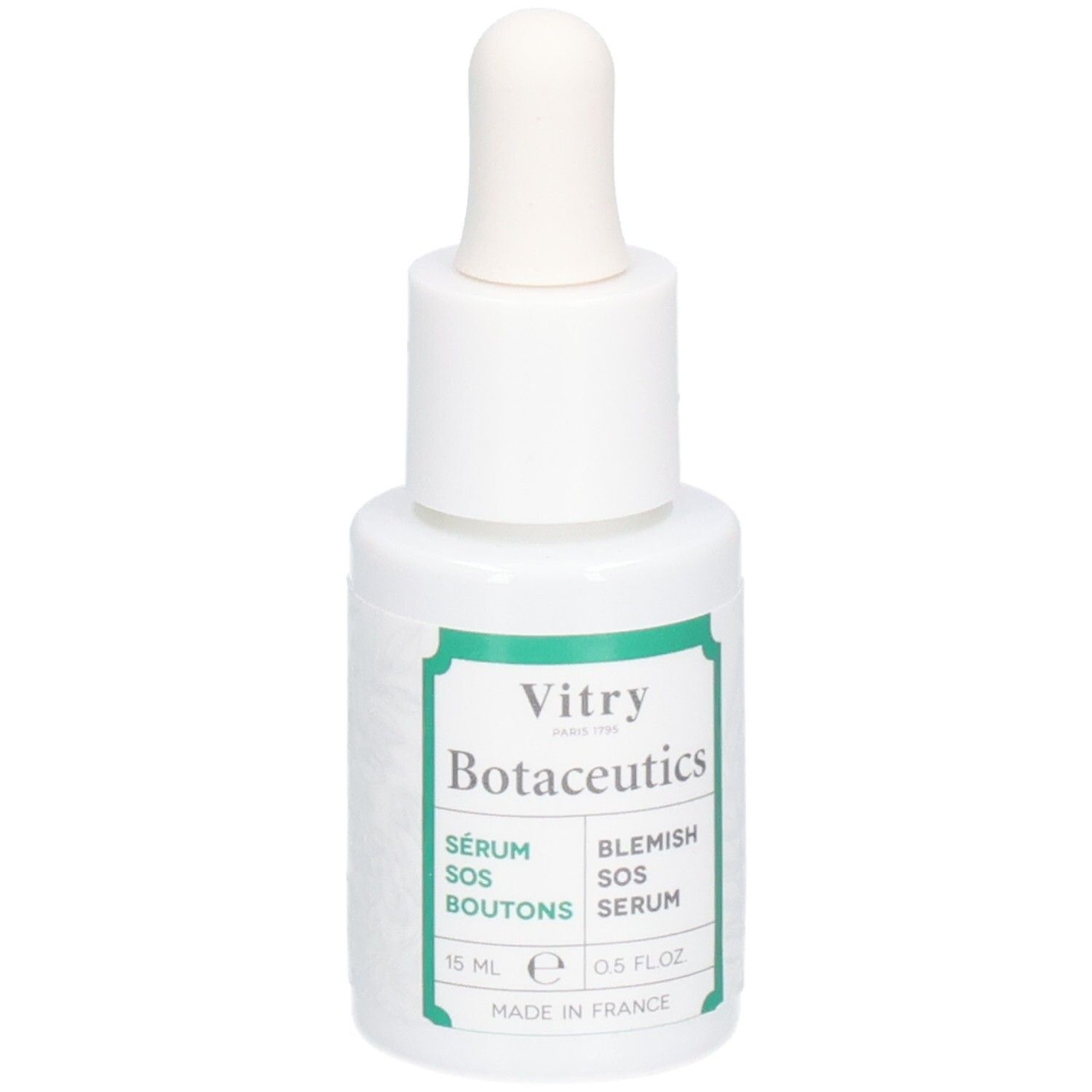 Flacon blanc avec compte-gouttes. Inscriptions : Vitry Botaceutics, Sérum SOS Boutons, Blemish SOS Serum. Étiquettes vertes. 15 ml.