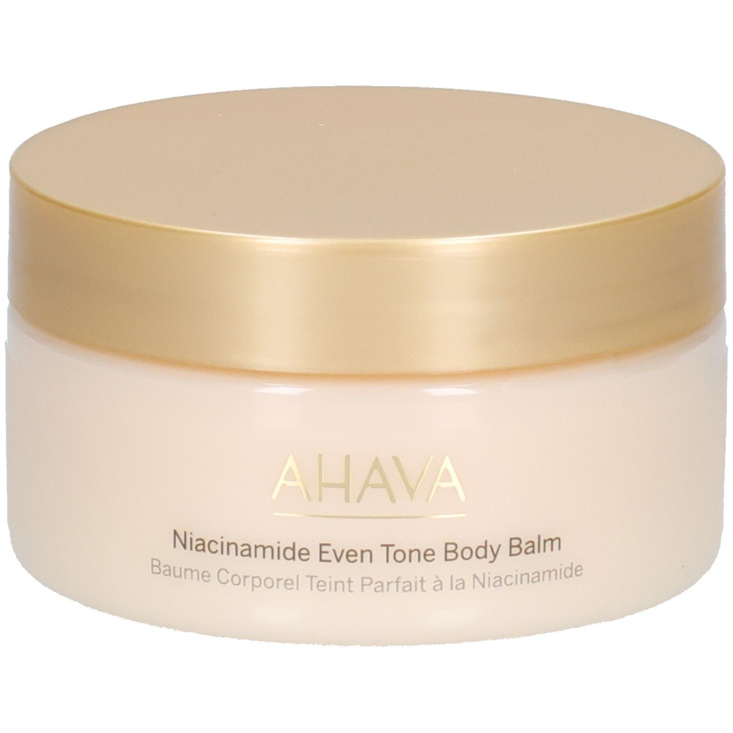 Pot de crème avec couvercle doré. Inscription : AHAVA, Niacinamide Even Tone Body Balm, Baume Corporel Teint Parfait à la Niacinamide.