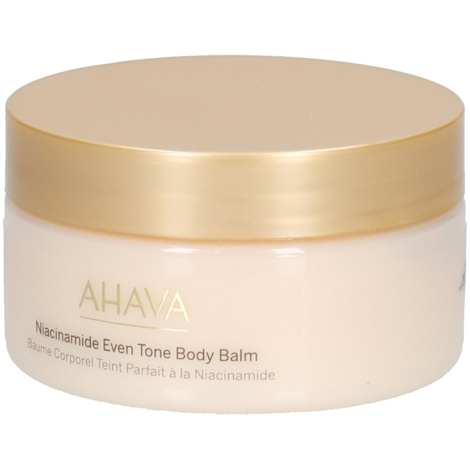 Pot de crème avec couvercle doré. Inscription : AHAVA, Niacinamide Even Tone Body Balm, Baume Corporel Teint Parfait à la Niacinamide.