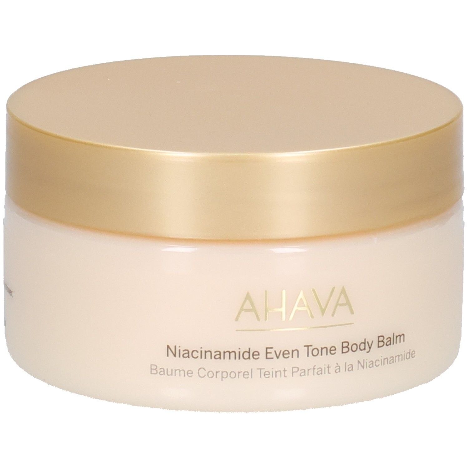 Pot de crème avec couvercle doré. Inscription : AHAVA, Niacinamide Even Tone Body Balm, Baume Corporel Teint Parfait à la Niacinamide.