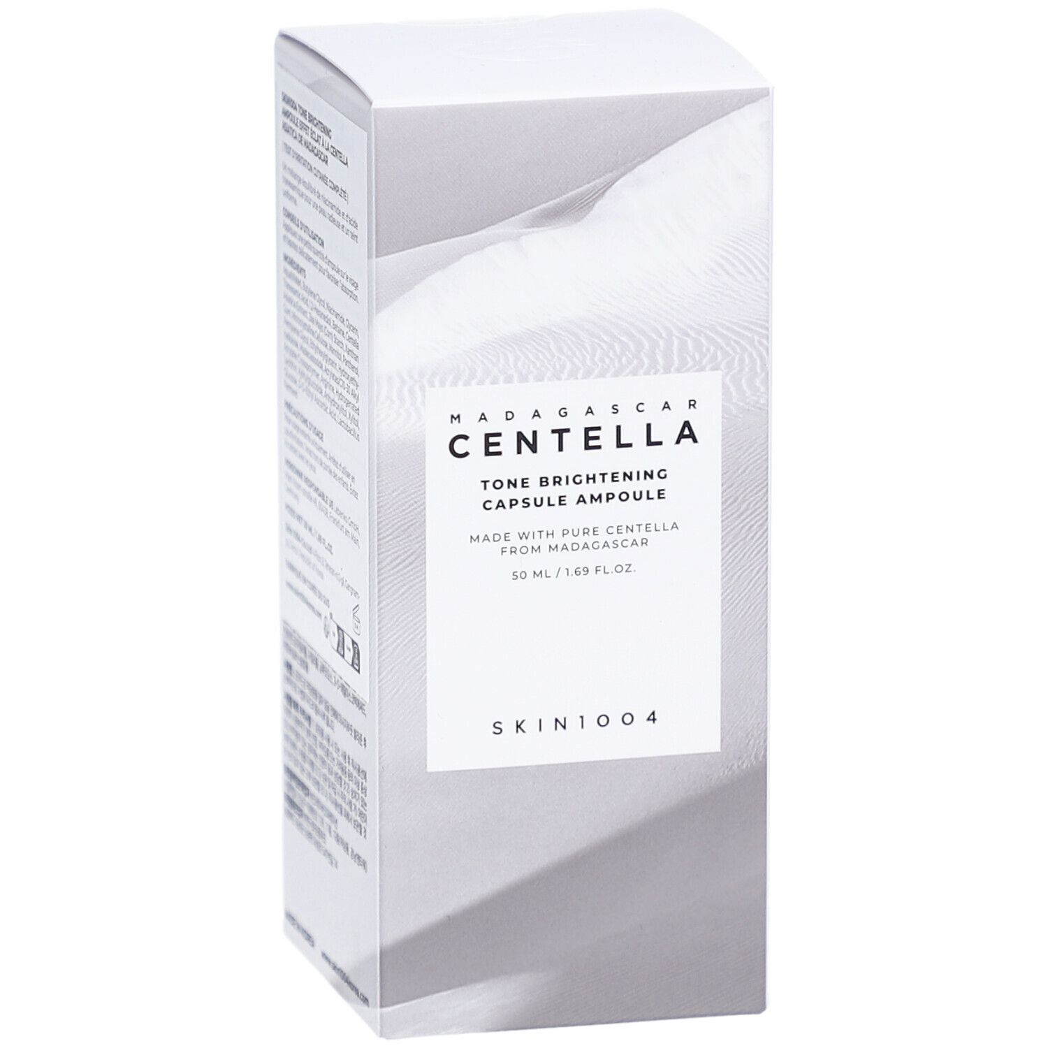 Boîte blanche avec informations produit. Texte: MADAGASCAR CENTELLA, Tone Brightening Capsule Ampoule, SKIN1004.