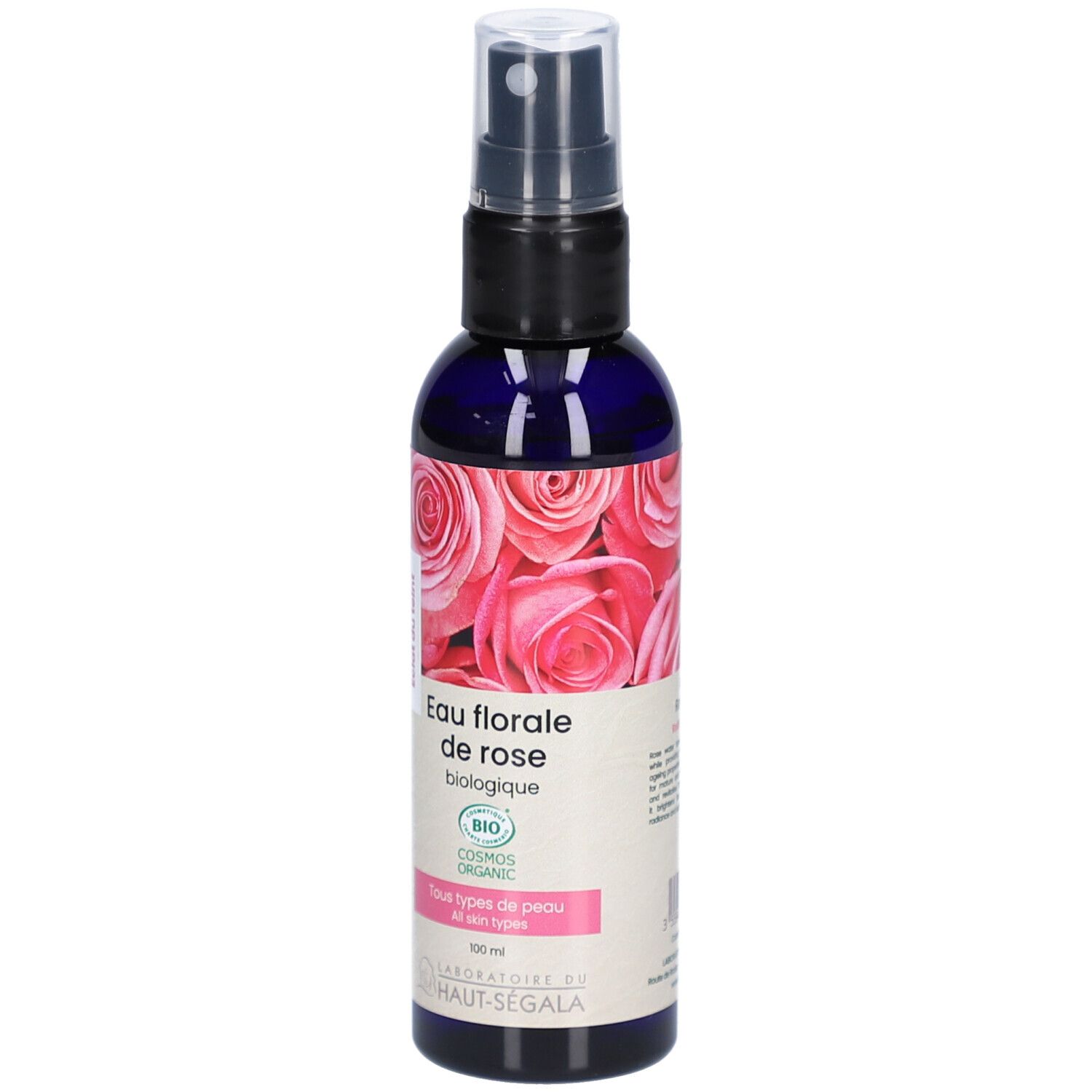 Flacon bleu transparent avec vaporisateur. Étiquette avec motif de roses et texte: Eau florale de rose biologique. Certification bio.