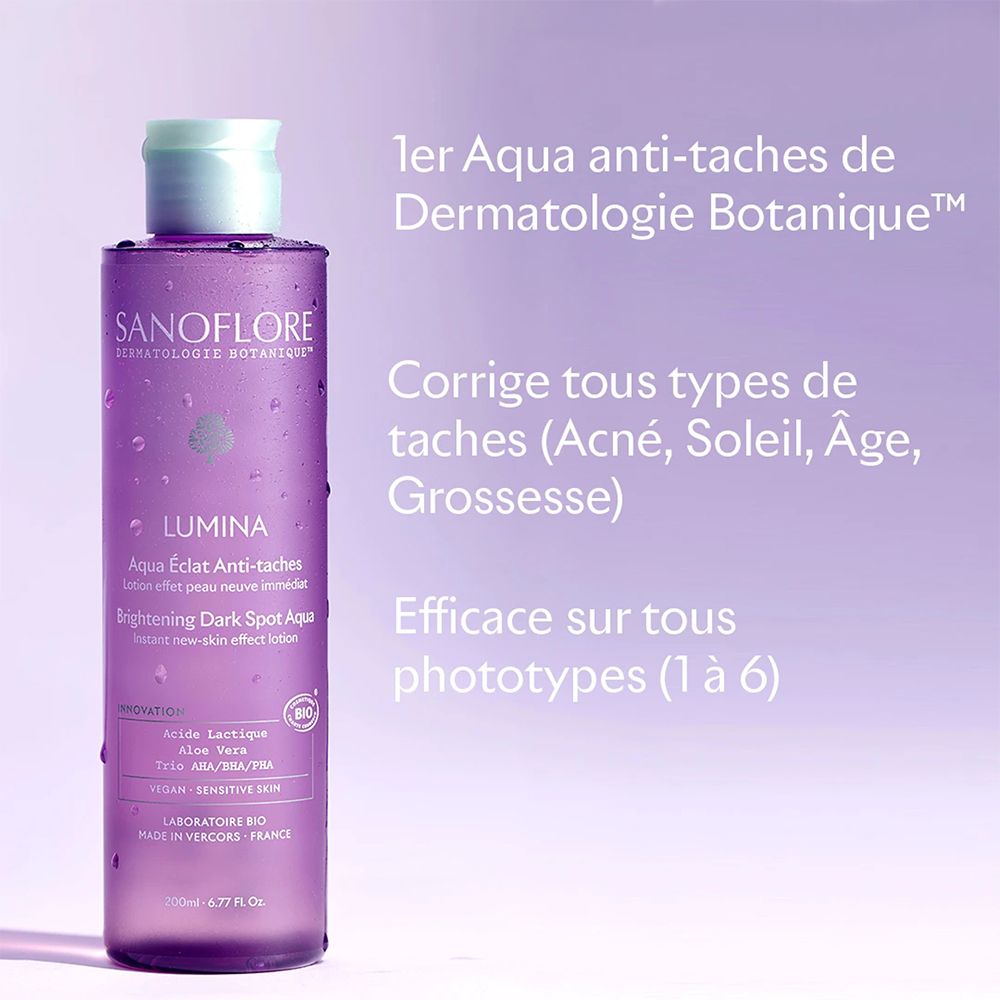 Flacon violet avec texte: LUMINA, Aqua Eclat Anti-taches, Brightening Dark Spot Aqua. Texte: 1er Aqua anti-taches.