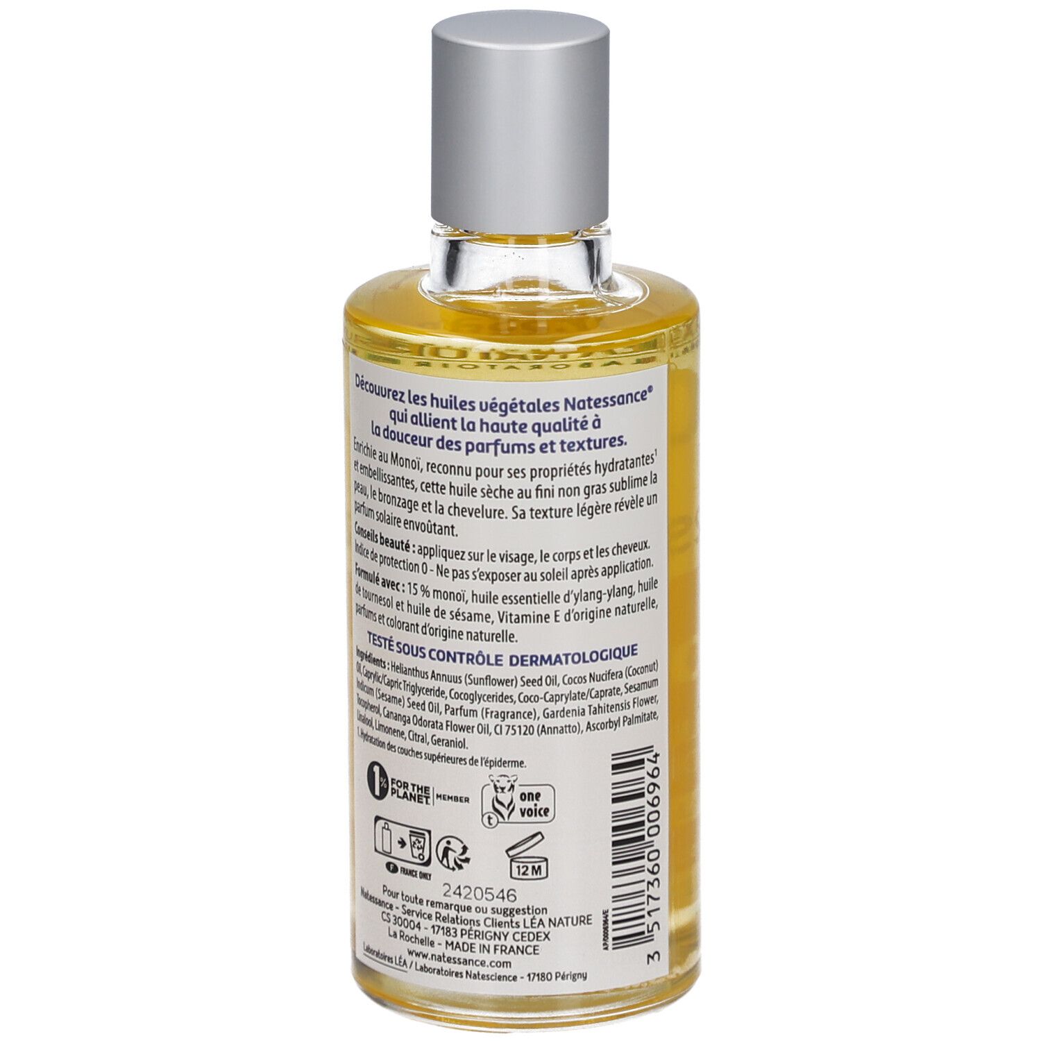 Flacon d'huile sèche Monoï Natessance. Étiquette orange avec fleurs blanches. Bouchon argenté.