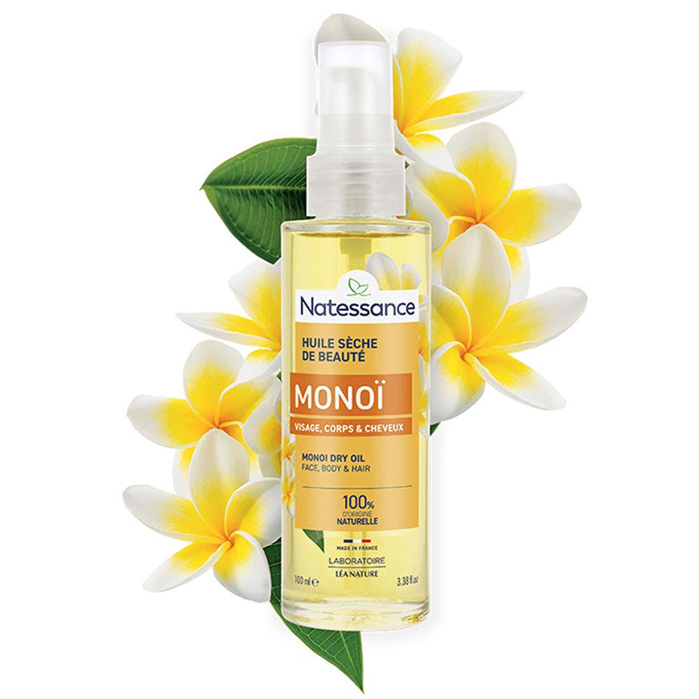 Flacon d'huile avec vaporisateur, entouré de fleurs. Inscription: Natessance Monoï. 100% naturel.