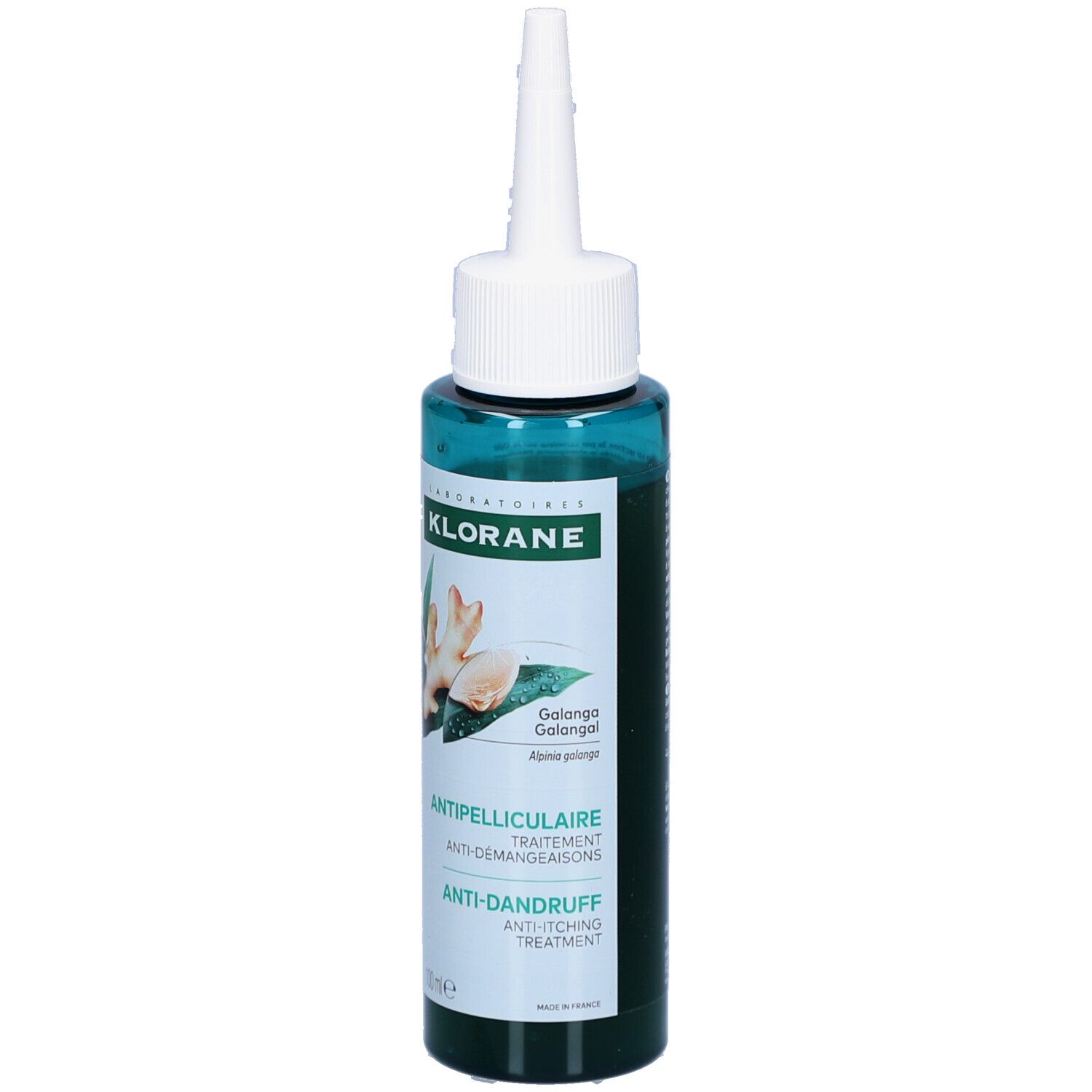 Flacon vert avec applicateur blanc. Inscriptions: KLORANE, Antipelliculaire, Anti-Démangeaisons, Anti-Dandruff Treatment. Illustration de gingembre.