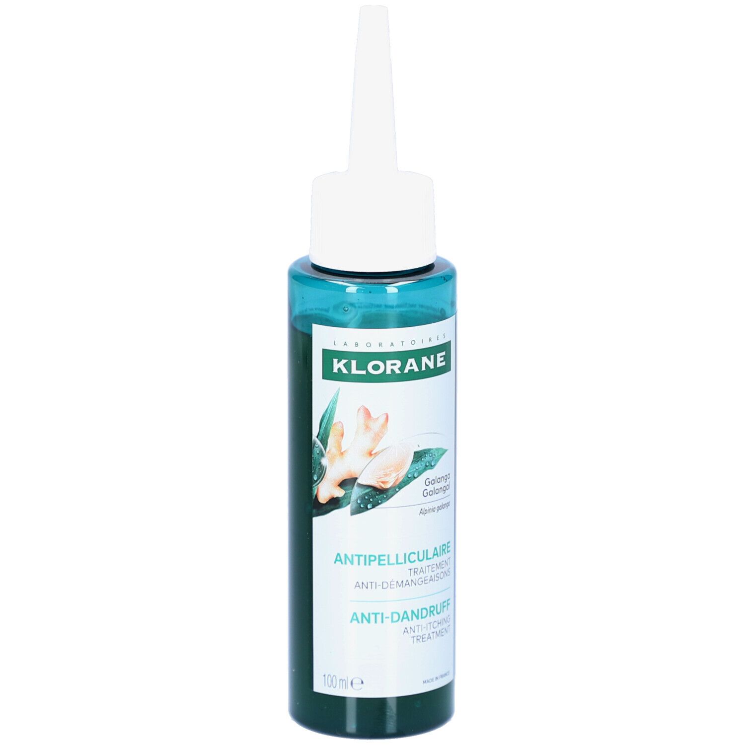 Flacon vert avec applicateur blanc. Inscriptions: KLORANE, Antipelliculaire, Anti-Démangeaisons, Anti-Dandruff Treatment. Illustration de gingembre.