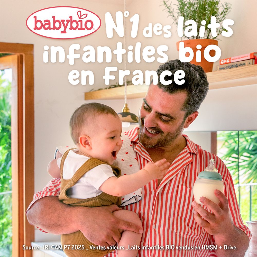 Un homme tient un bébé. Biberon Babybio. Inscription : Babybio, N°1 des laits infantiles bio en France.
