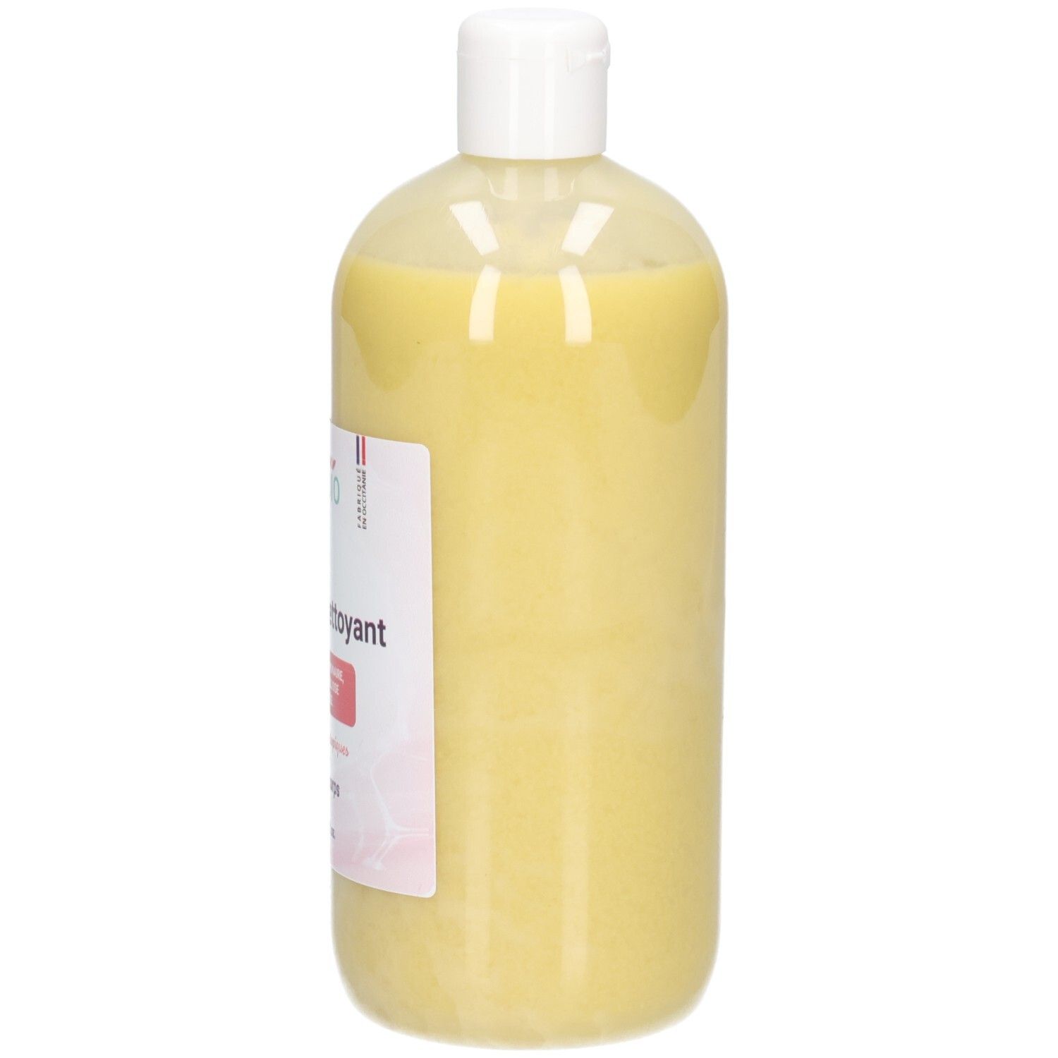 Côté d'un flacon de liniment jaune, bouchon blanc.