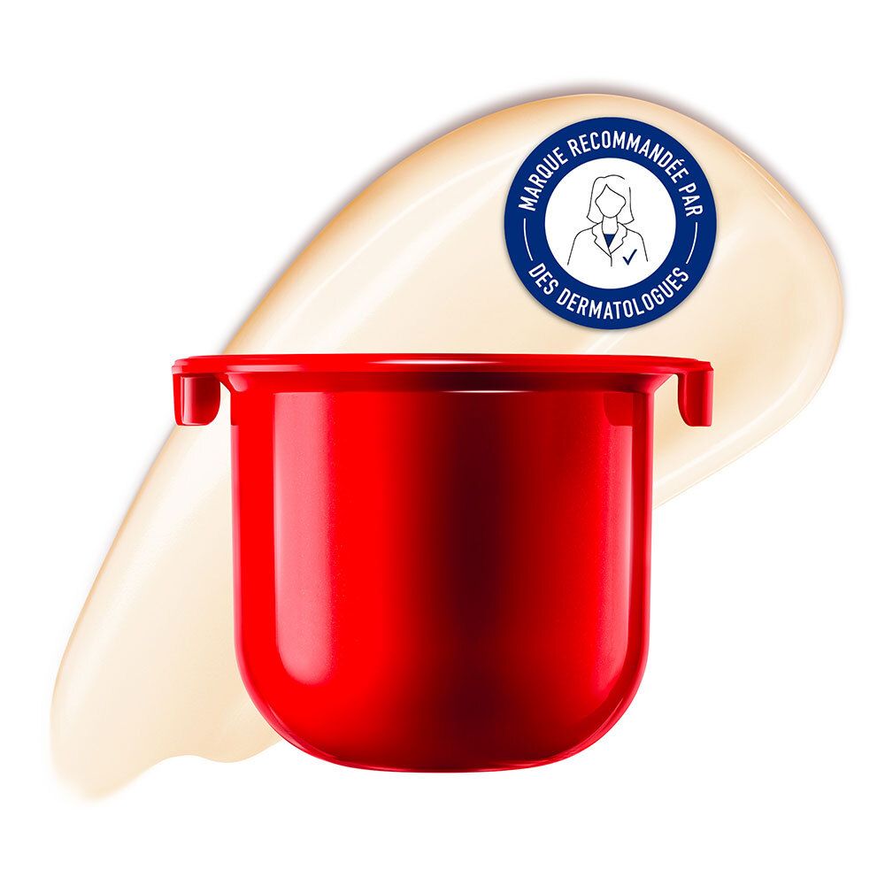 Pot rouge avec crème et sceau de recommandation dermatologique. Texture crème sur fond clair.