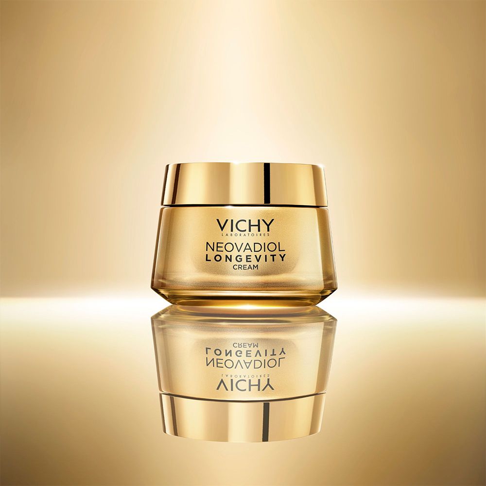 Pot doré. Inscription: VICHY, NEOVADIOL LONGEVITY CREAM. Reflet.