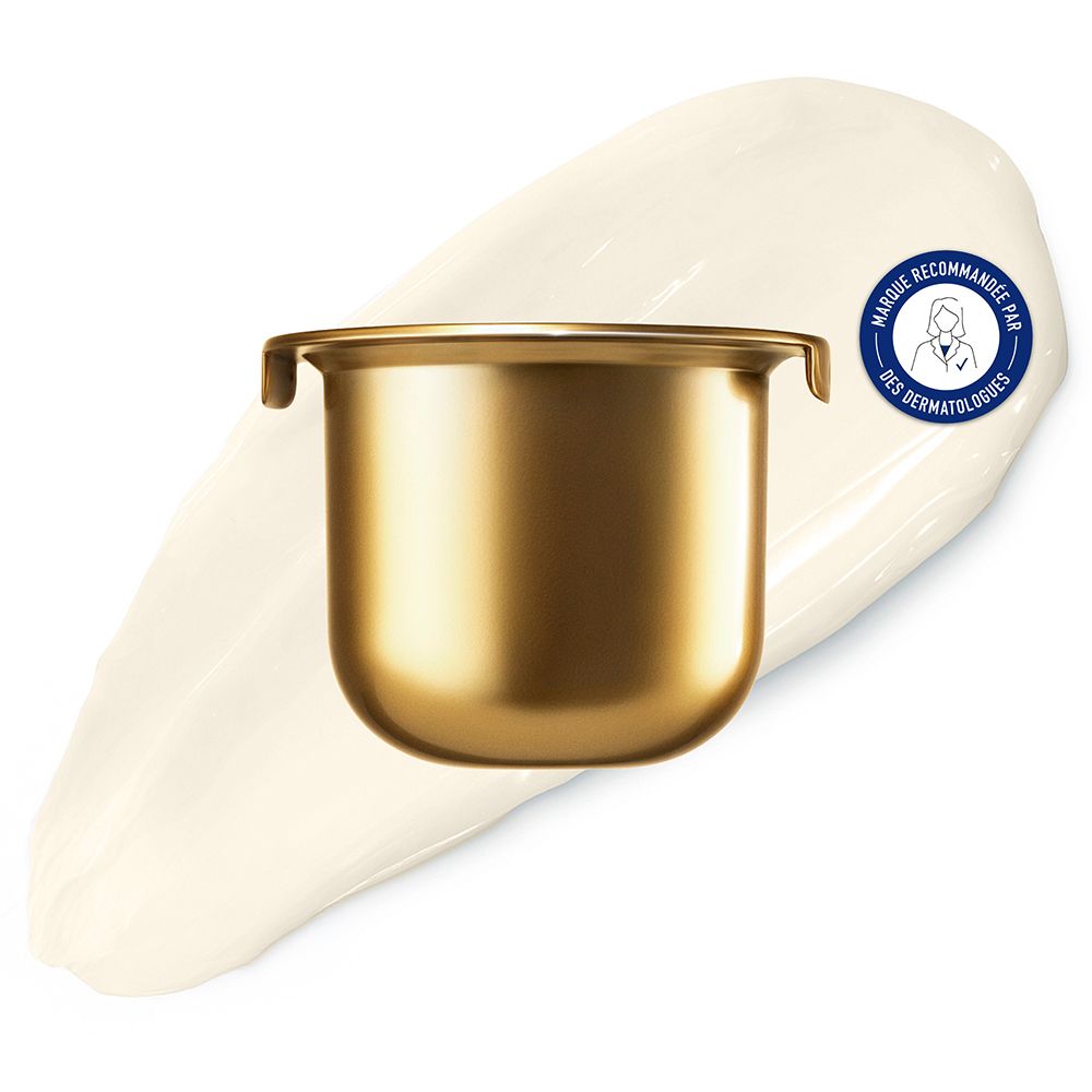 Récipient doré sur une trace de crème. Cercle bleu avec texte.