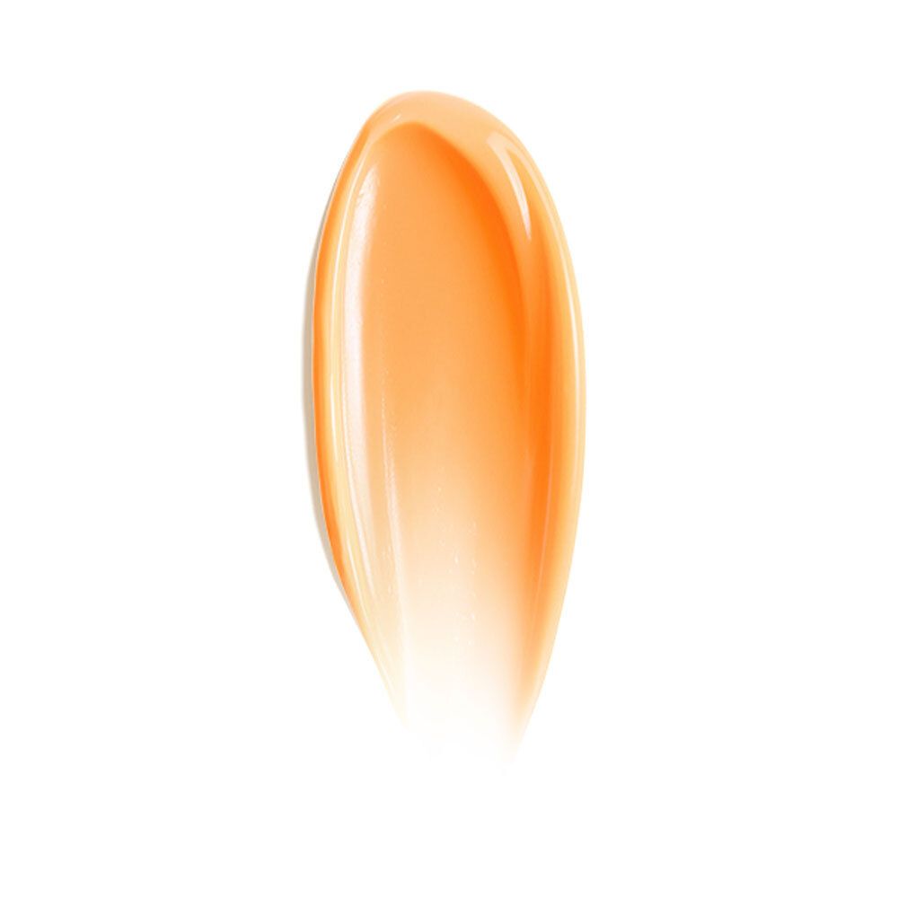 Goutte de gel orangé brillant sur fond blanc. Forme allongée, en forme de goutte.