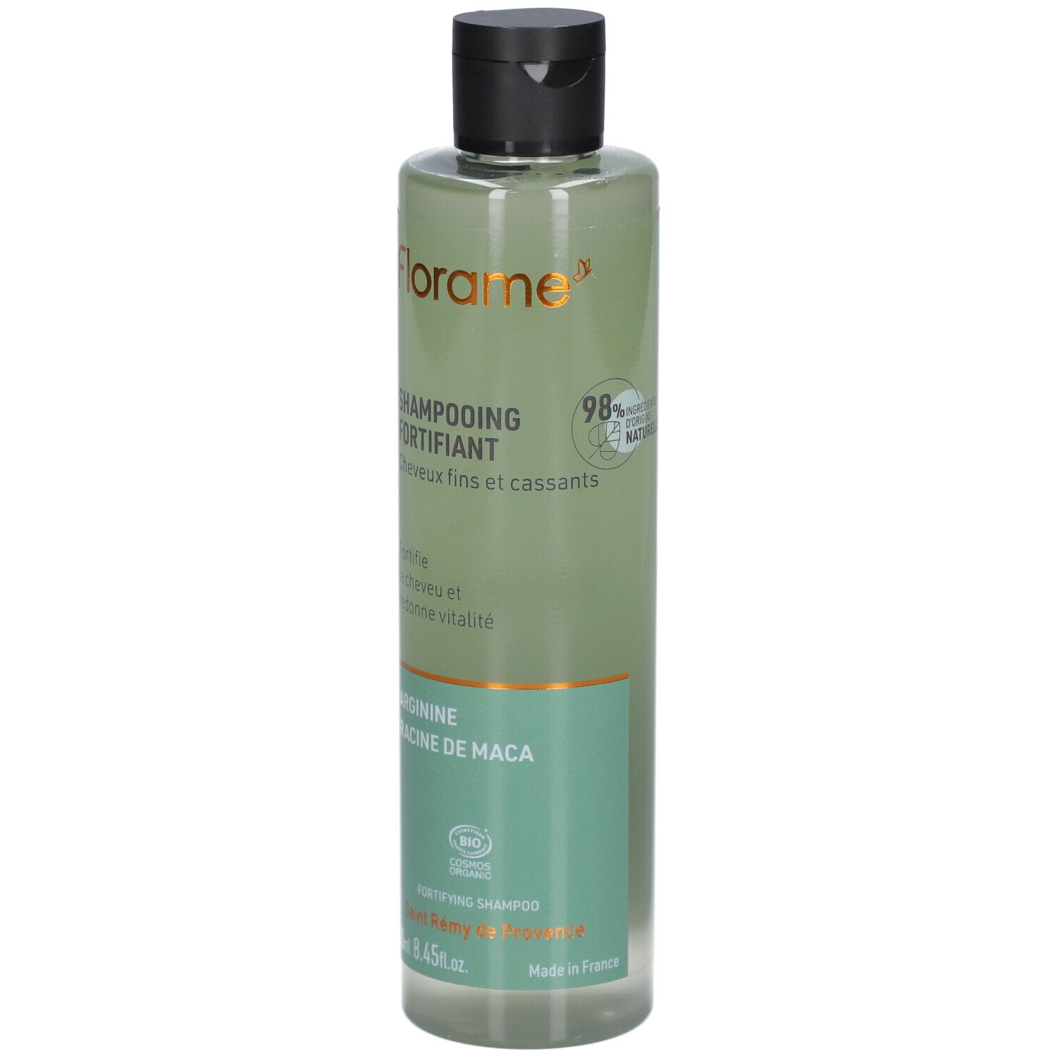 Flacon de shampooing vert avec bouchon noir. Inscriptions: FLORAME, Shampooing Fortifiant, Arginine, Racine de Maca. 98% ingrédients naturels.