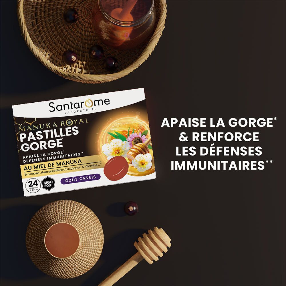 Boîte de Pastilles Gorge Manuka Royal SANTAROME LABORATOIRE sur fond noir. Miel, fleurs et pastille rouge. Autres éléments.