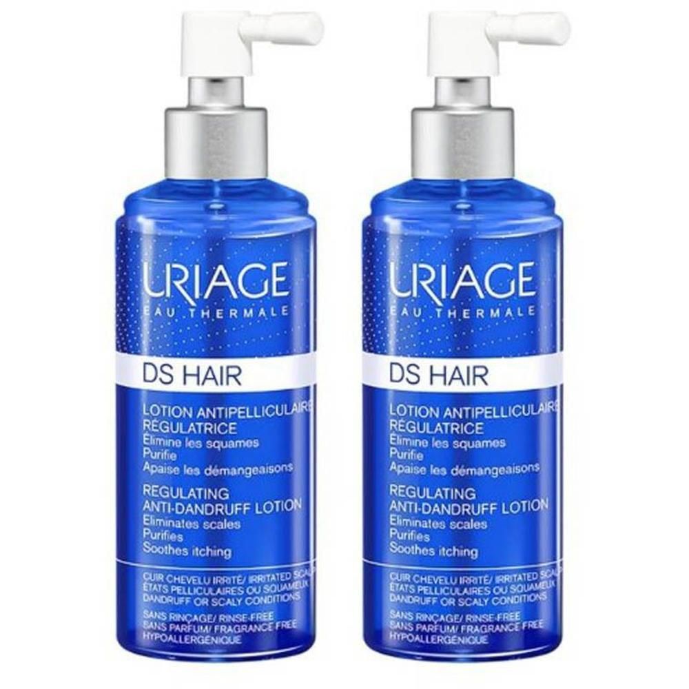 Deux flacons bleus URIAGE DS HAIR Lotion Spray. Têtes de pulvérisation blanches. Texte: DS HAIR, Lotion Antipelliculaire Régulatrice.
