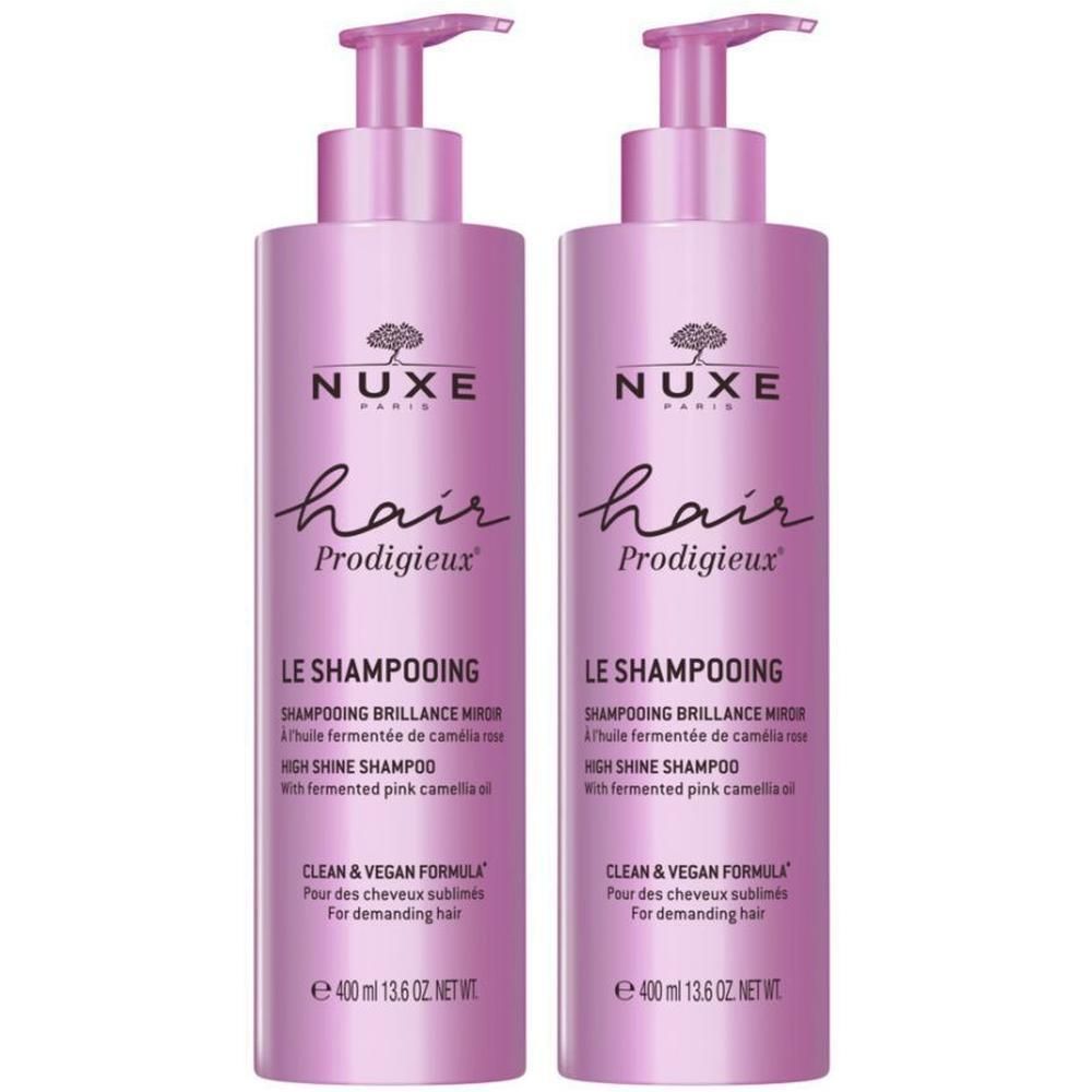 Deux flacons de shampooing roses. Inscription: Nuxe Hair Prodigieux, Le Shampooing, High Shine Shampoo. Avec pompe.
