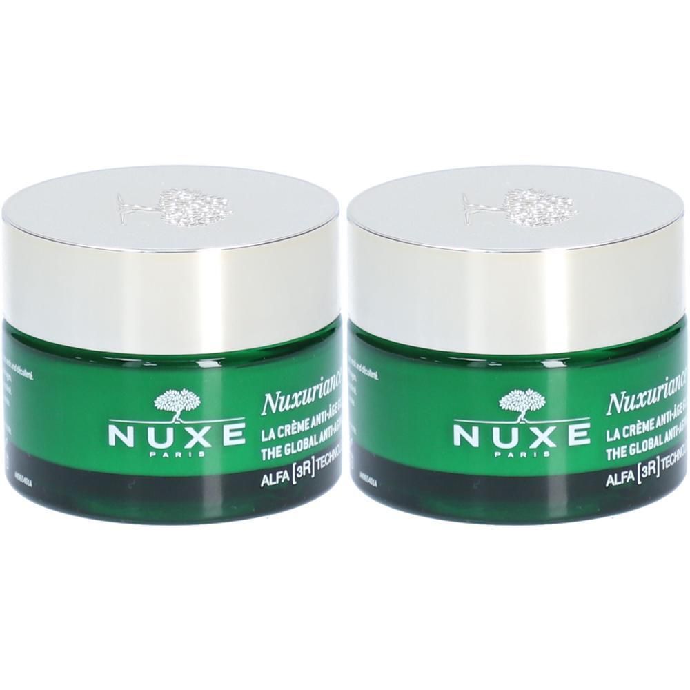 Deux pots de crème verts avec couvercles argentés. Inscription : NUXE Paris, Nuxuriance Ultra, La Crème Anti-Âge Global.