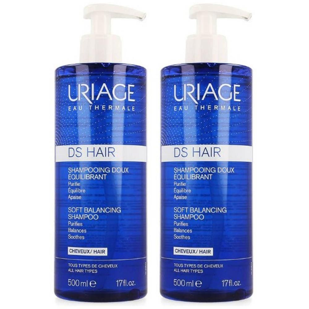 Deux flacons bleus de Uriage DS Hair Shampooing Doux Équilibrant. Pompes blanches. Texte en français et anglais.