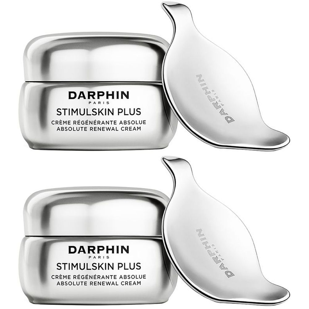 Deux pots de crème argentés et deux outils de massage argentés. Sur les pots, on lit "DARPHIN PARIS STIMULSKIN PLUS CRÈME RÉGÉNÉRANTE ABSOLUE".