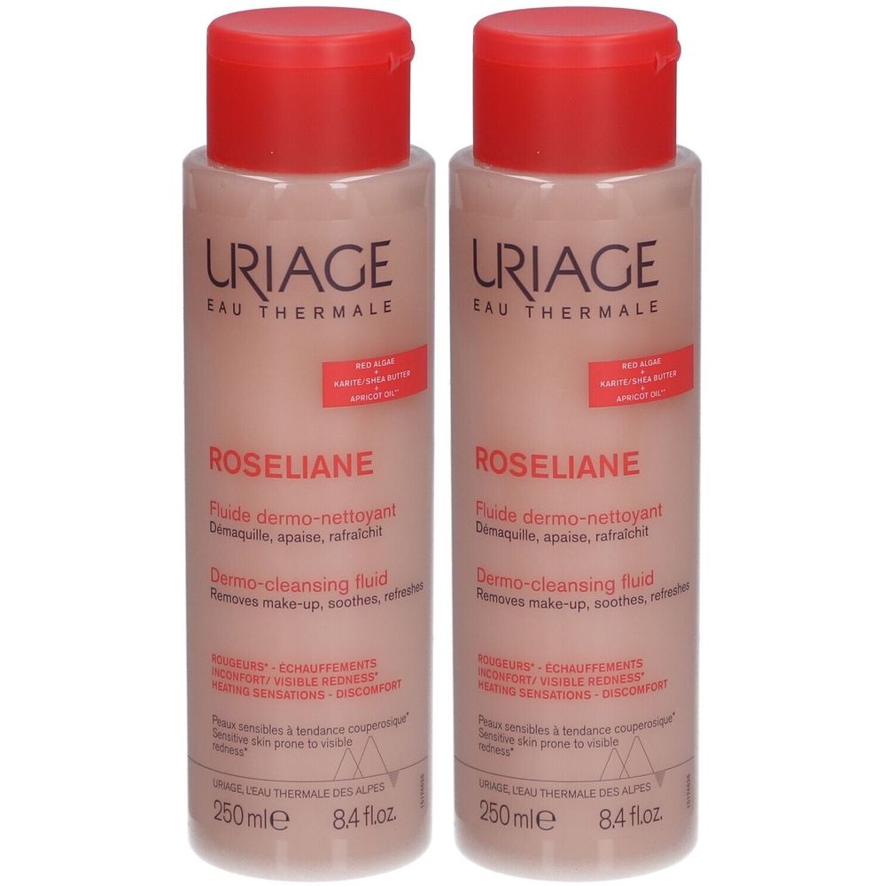 Deux flacons de Uriage Roséliane Fluide Dermo-Nettoyant. Liquide rose dans des flacons cylindriques avec bouchon rouge. Texte: Uriage, Roséliane.