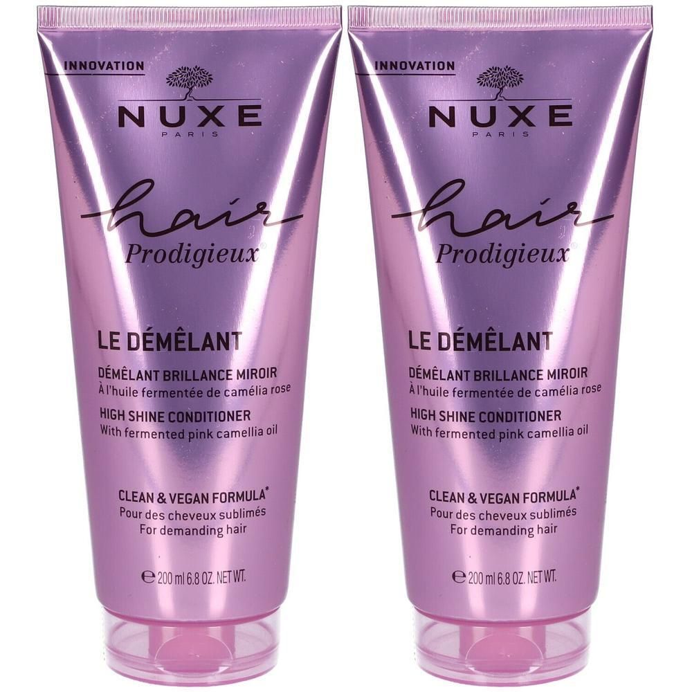Deux tubes de Nuxe Hair Prodigieux® Le Démêlant. Teinte rose-violet, texte et informations produit.