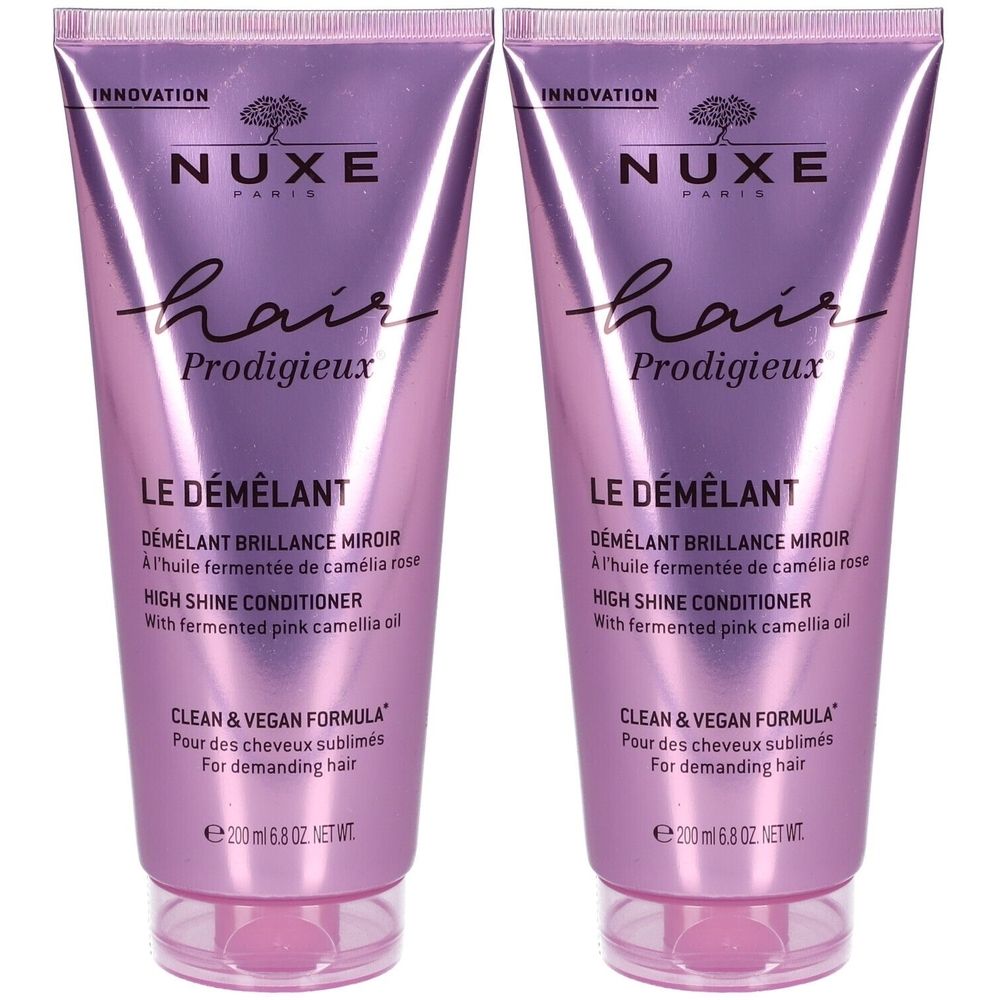 Deux tubes de NUXE Hair Prodigieux® Le Démêlant. Conditionneur brillant. Tubes rose-violet avec texte et informations.