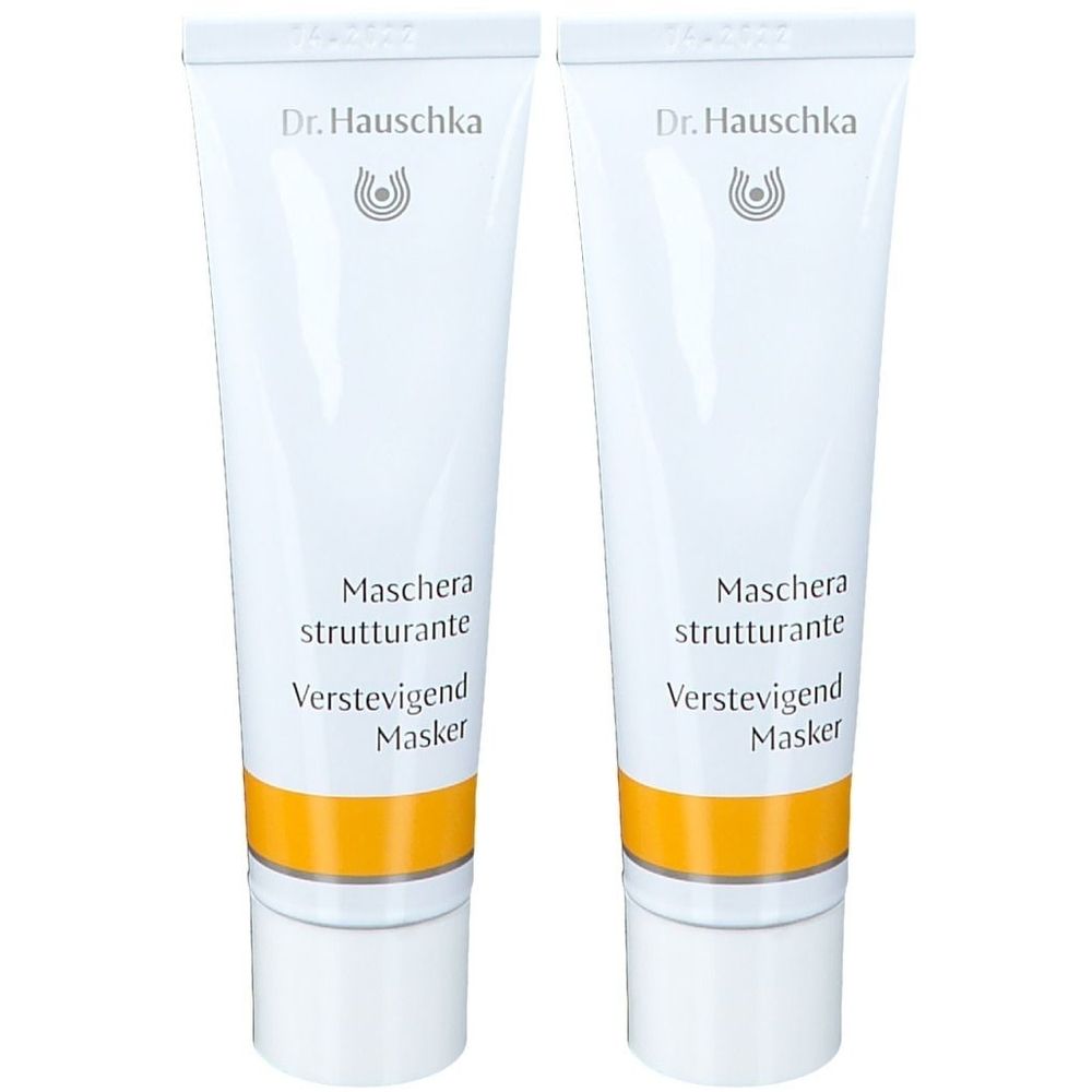 Deux tubes blancs avec une bande jaune. Inscription : Dr. Hauschka, Maschera strutturante, Verstevigend Masker.